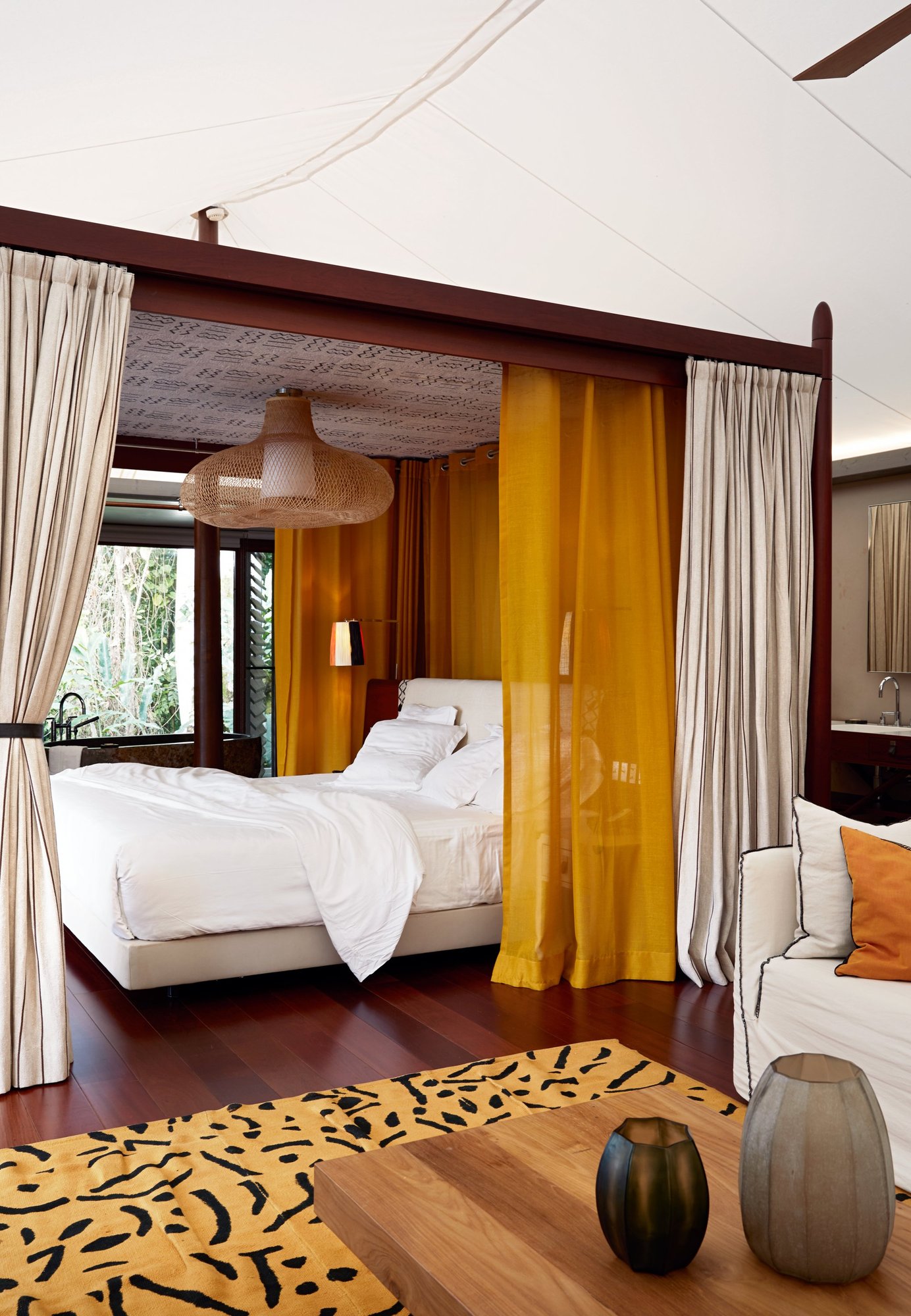 Bedroom inside a one bedroom forest villa at Sundy Praia raised on screw piles in mature forest