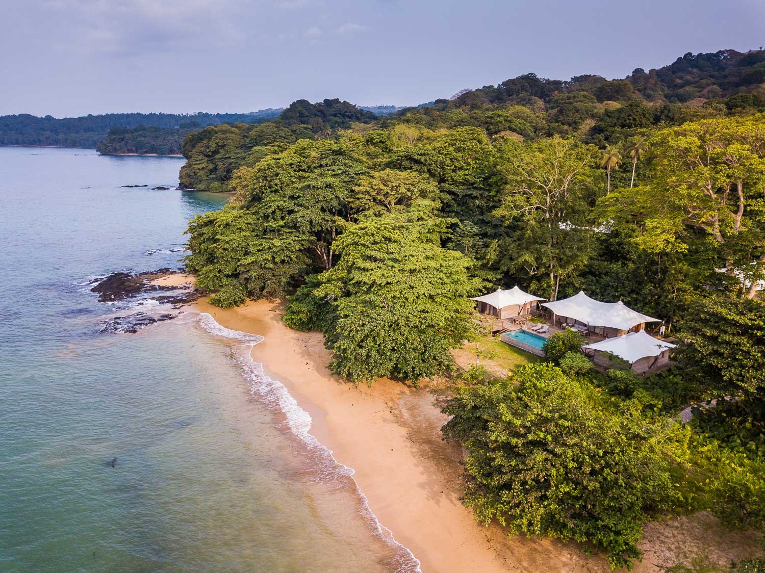 Aerial view of the three bedroom pool villa and infinity pool on the beach at Sundy Praia on Príncipe