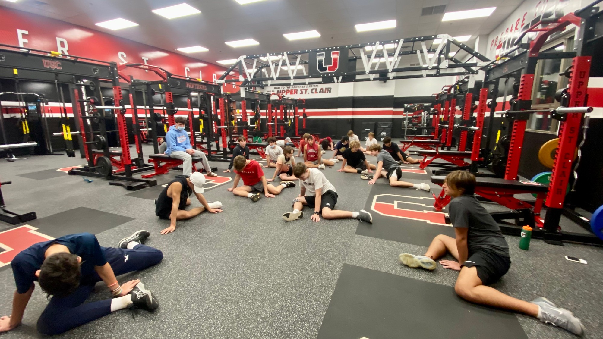Young athlete seated on a mat during Kinstretch class