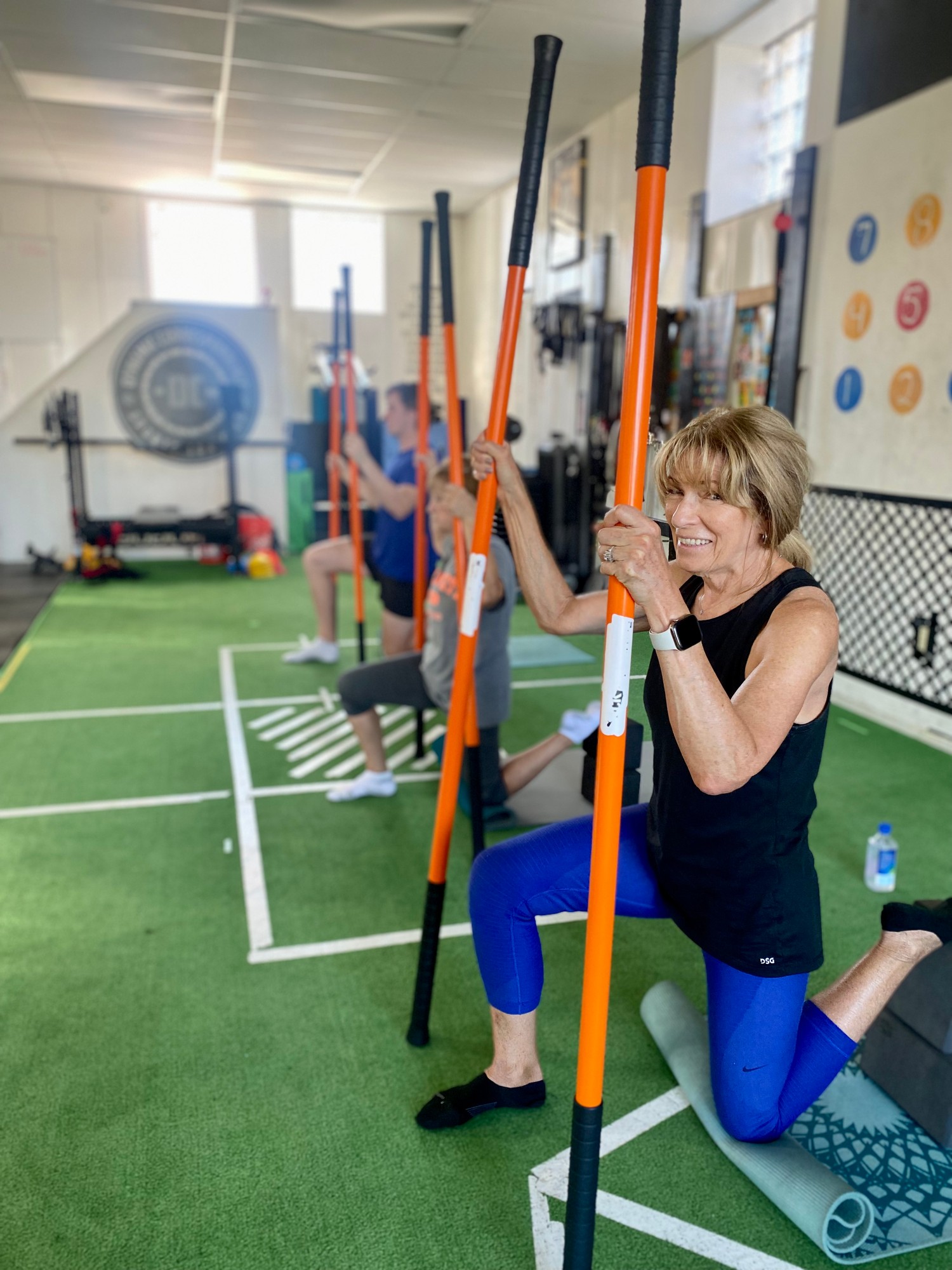 Clients performing wall-supported hip mobility drills