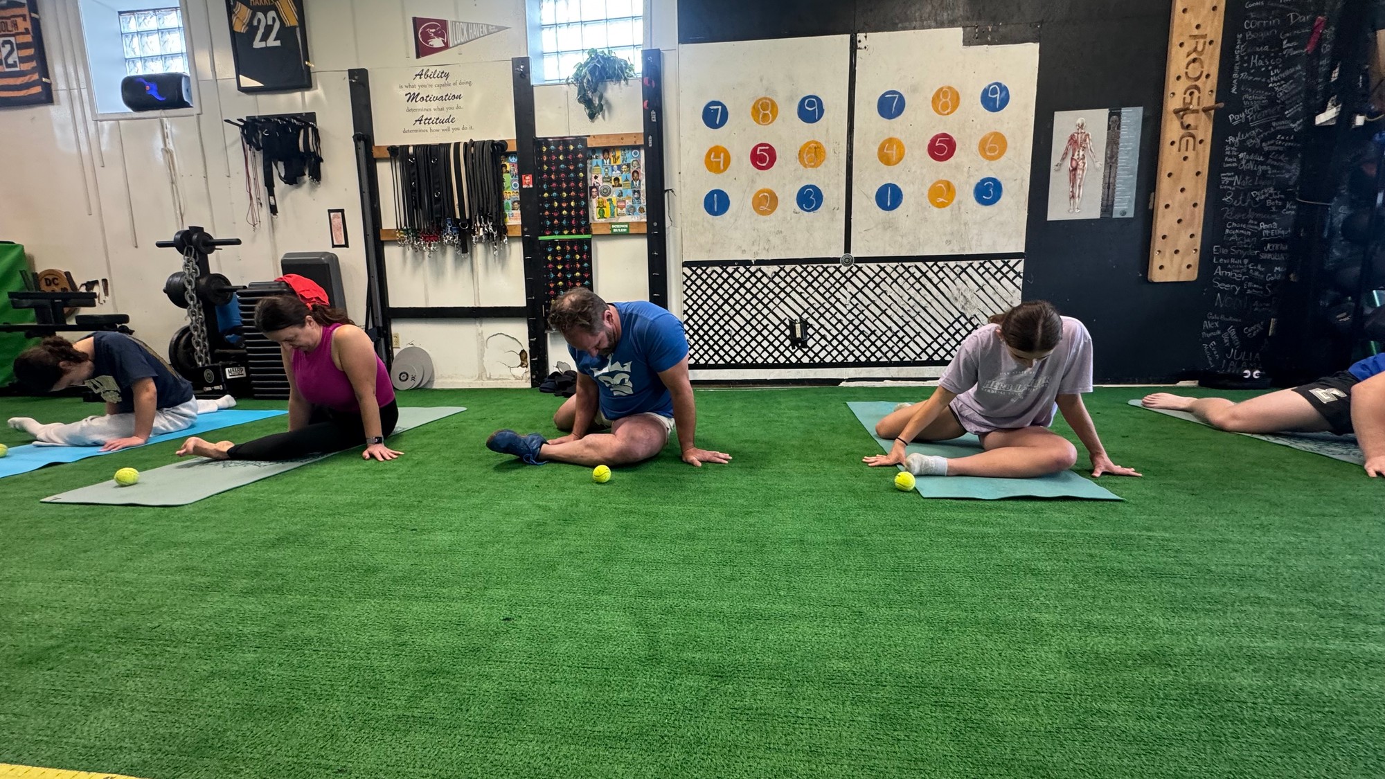 Group Kinstretch class stretching on mats at DC Sports Training