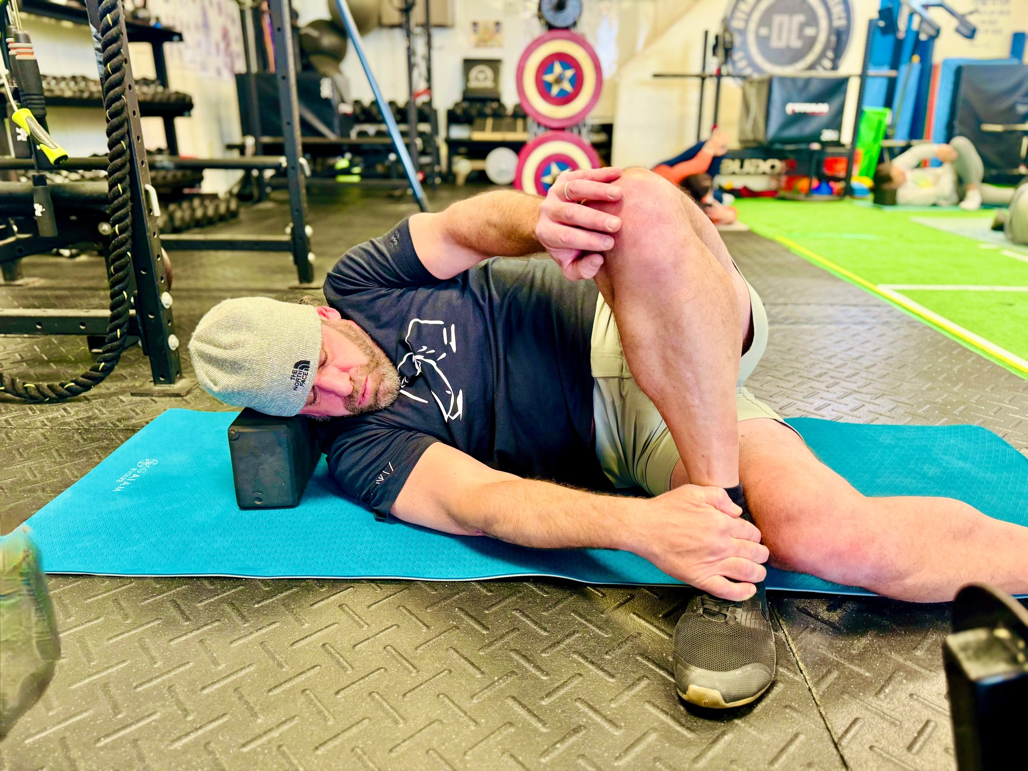 Older athlete smiling while using mobility sticks