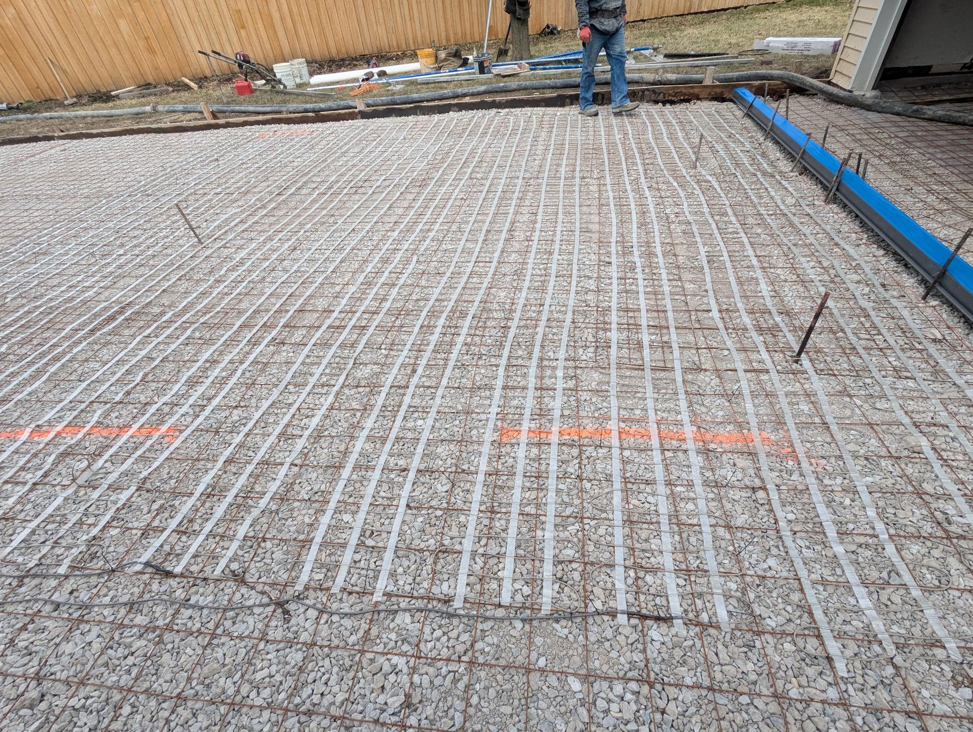 Full coverage heated driveway installation — heating cable grid laid over gravel base before concrete pour
