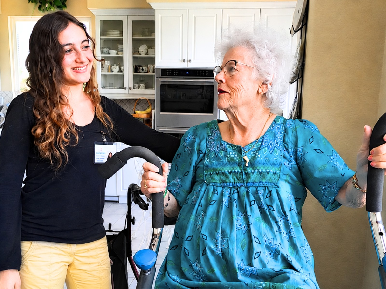 Caregiver helping elderly man with gentle exercise
