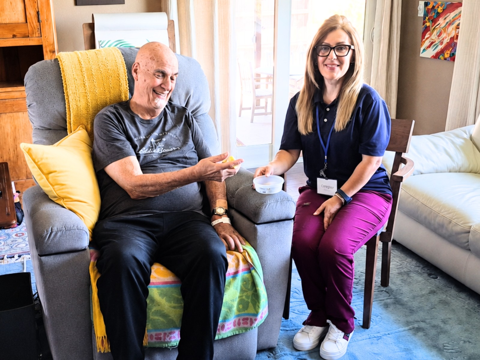 Caregiver assisting elderly client at home