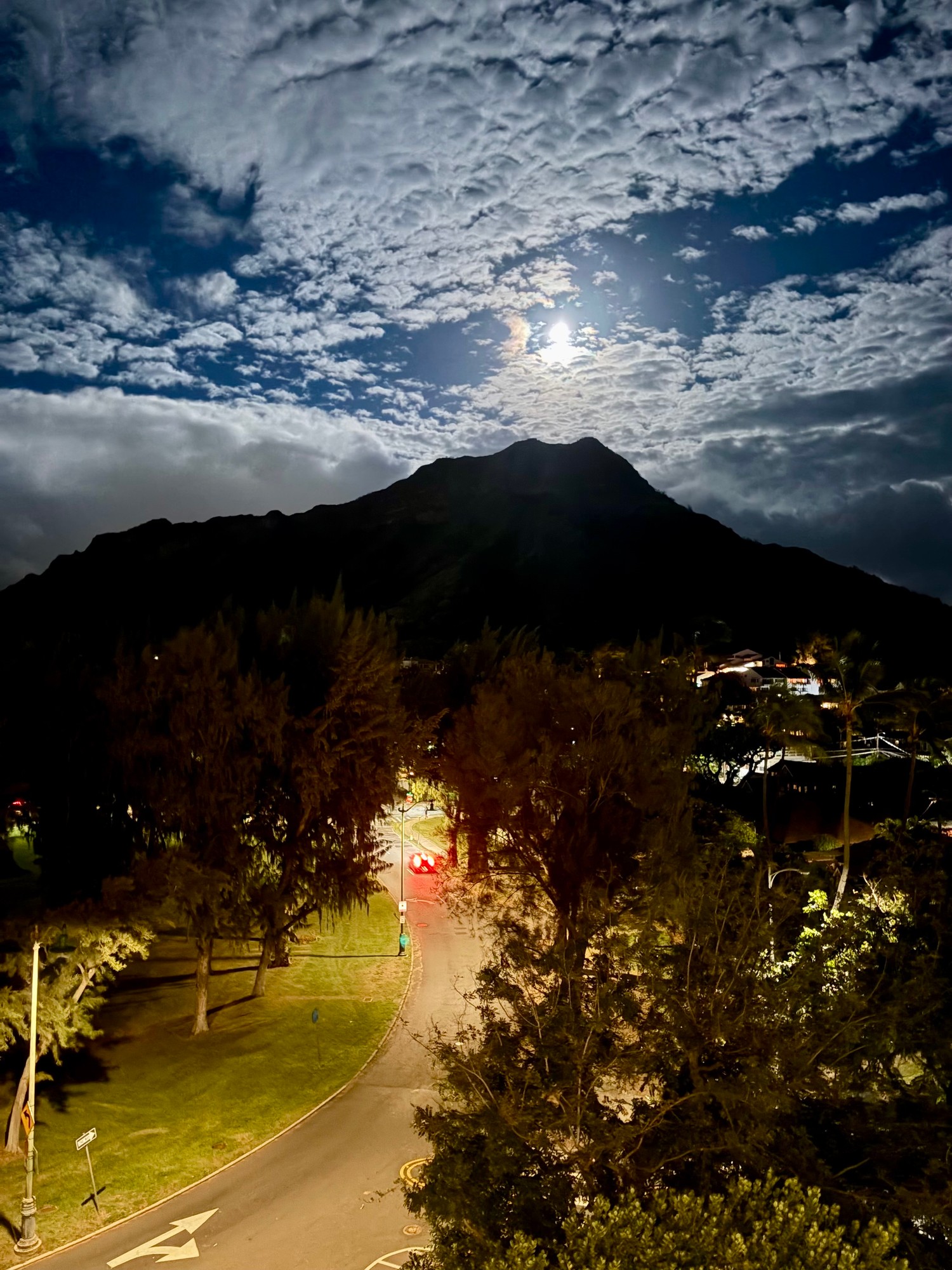 Diamond Head silhouette under moonlit sky at night