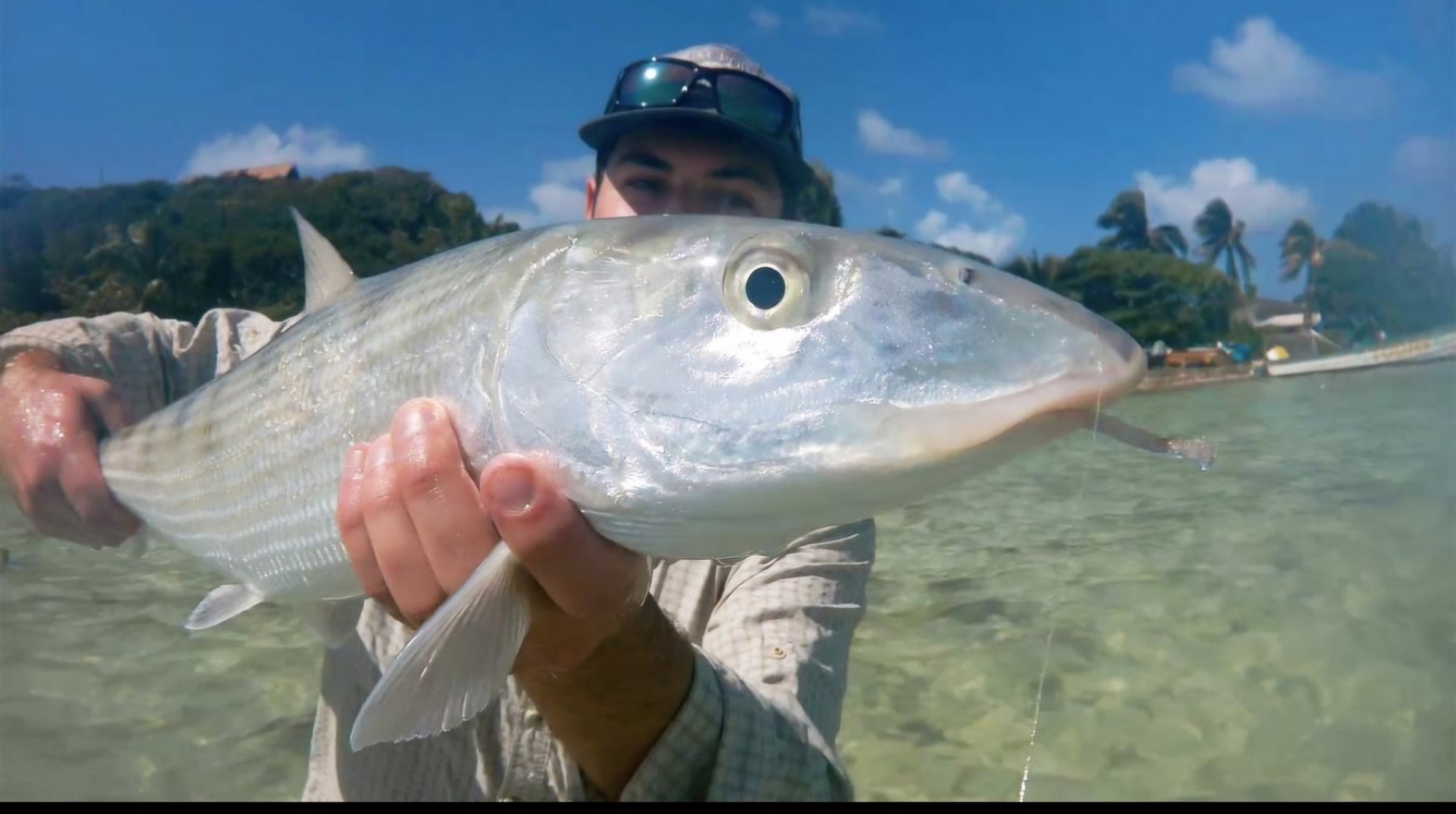 Angler with a bonefish caught fly fishing on the flats