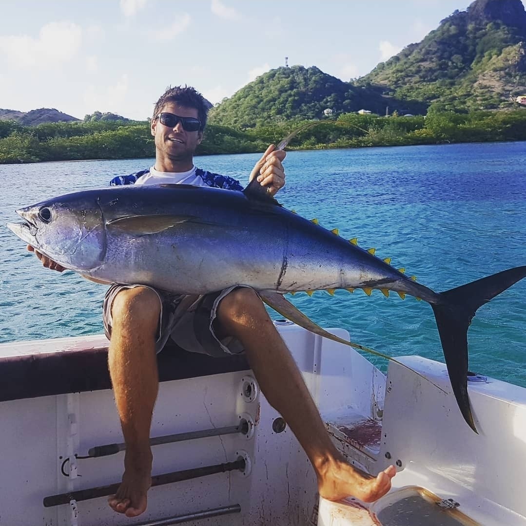 Angler with a big yellowfin tuna caught casting