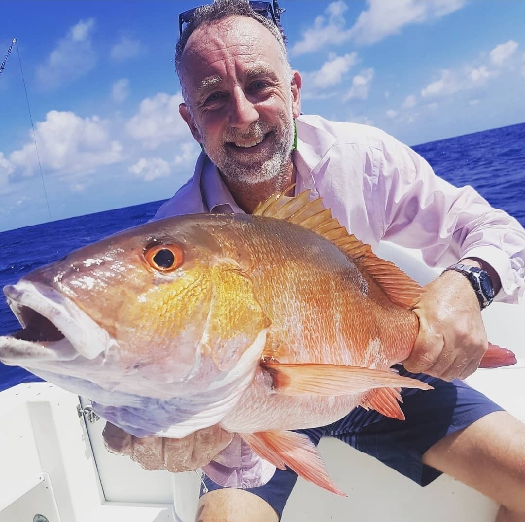 Angler with a big red snapper caught bottom fishing