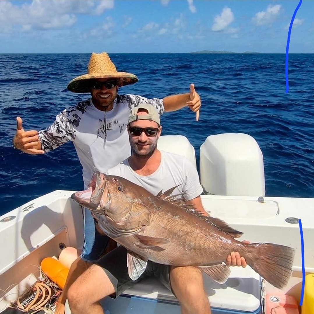 Anglers with a big grouper caught on a daytime deep drop