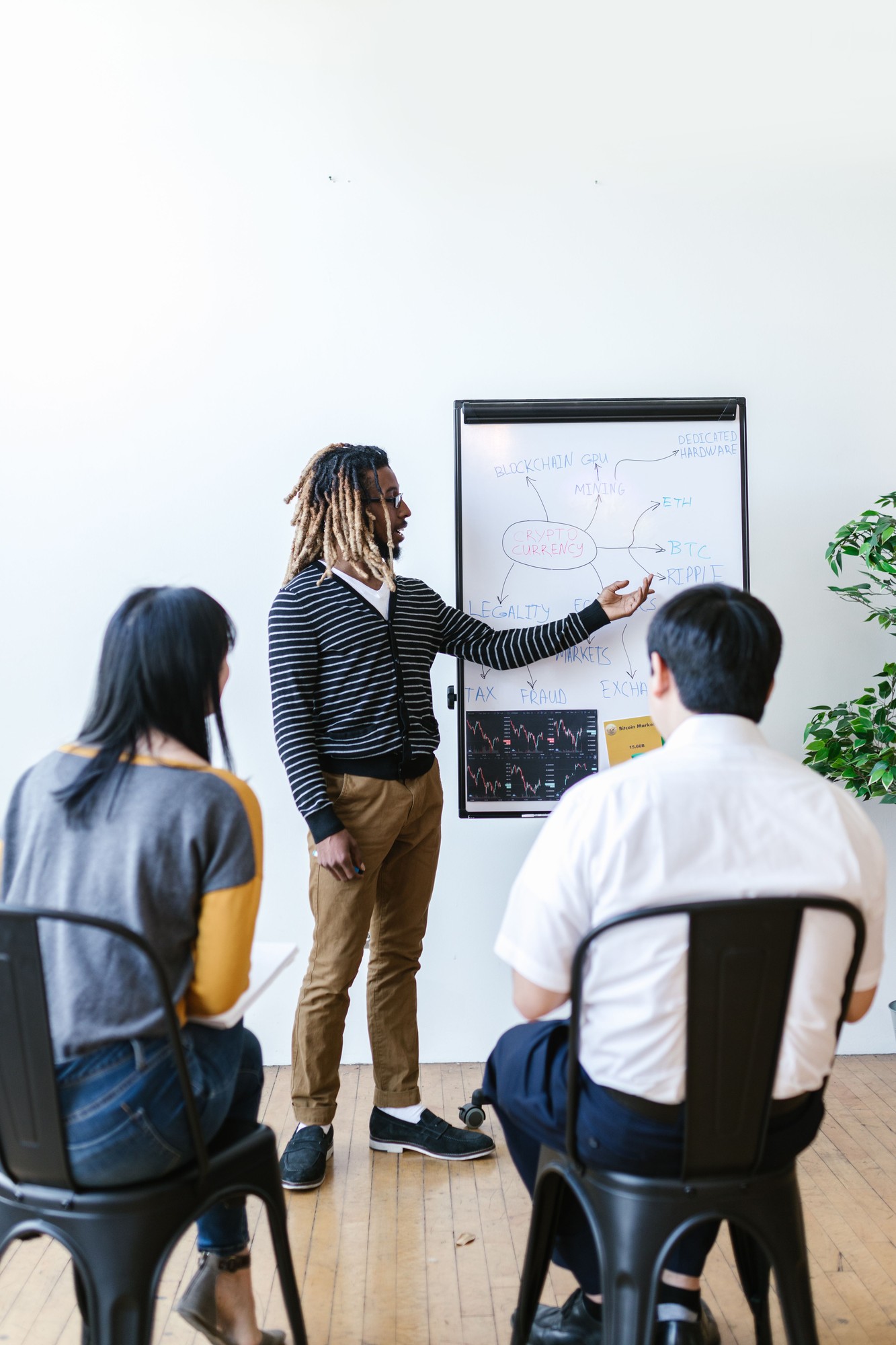 Diversita team members talking with a colleague in the office