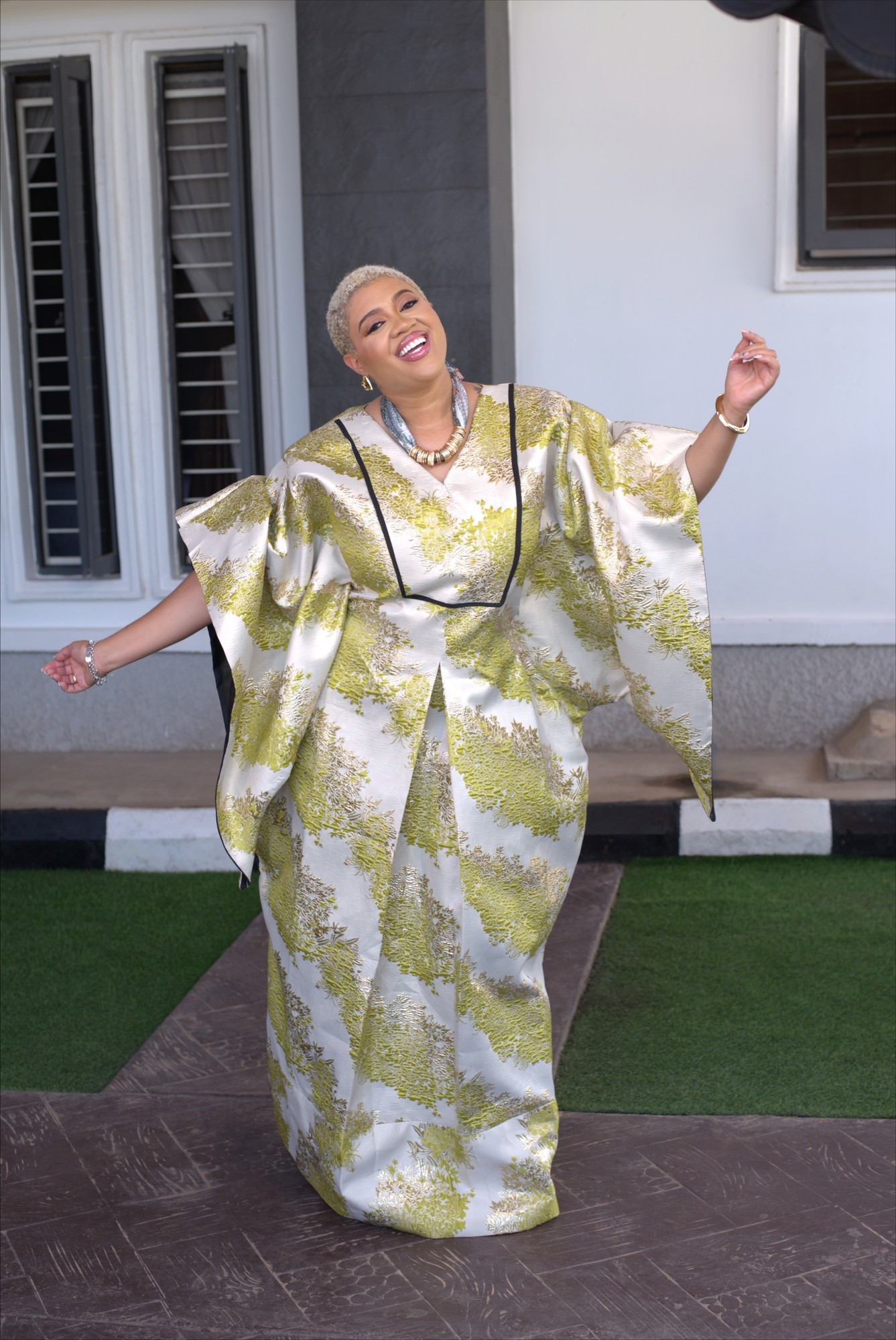 Chartreuse and gold brocade angel-sleeve kaftan with black trim at neckline and cuffs