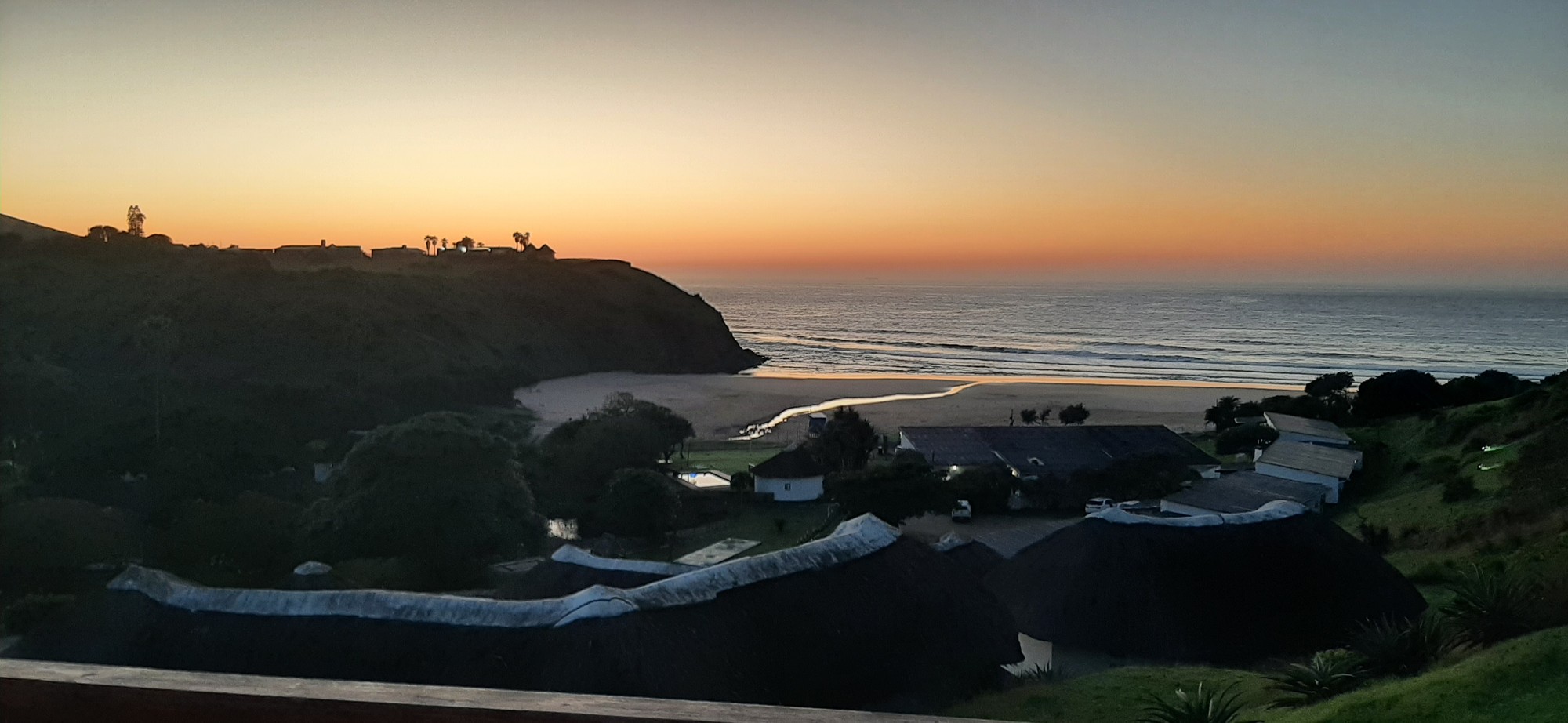 Twilight panorama of the bay and cottages from the hillside