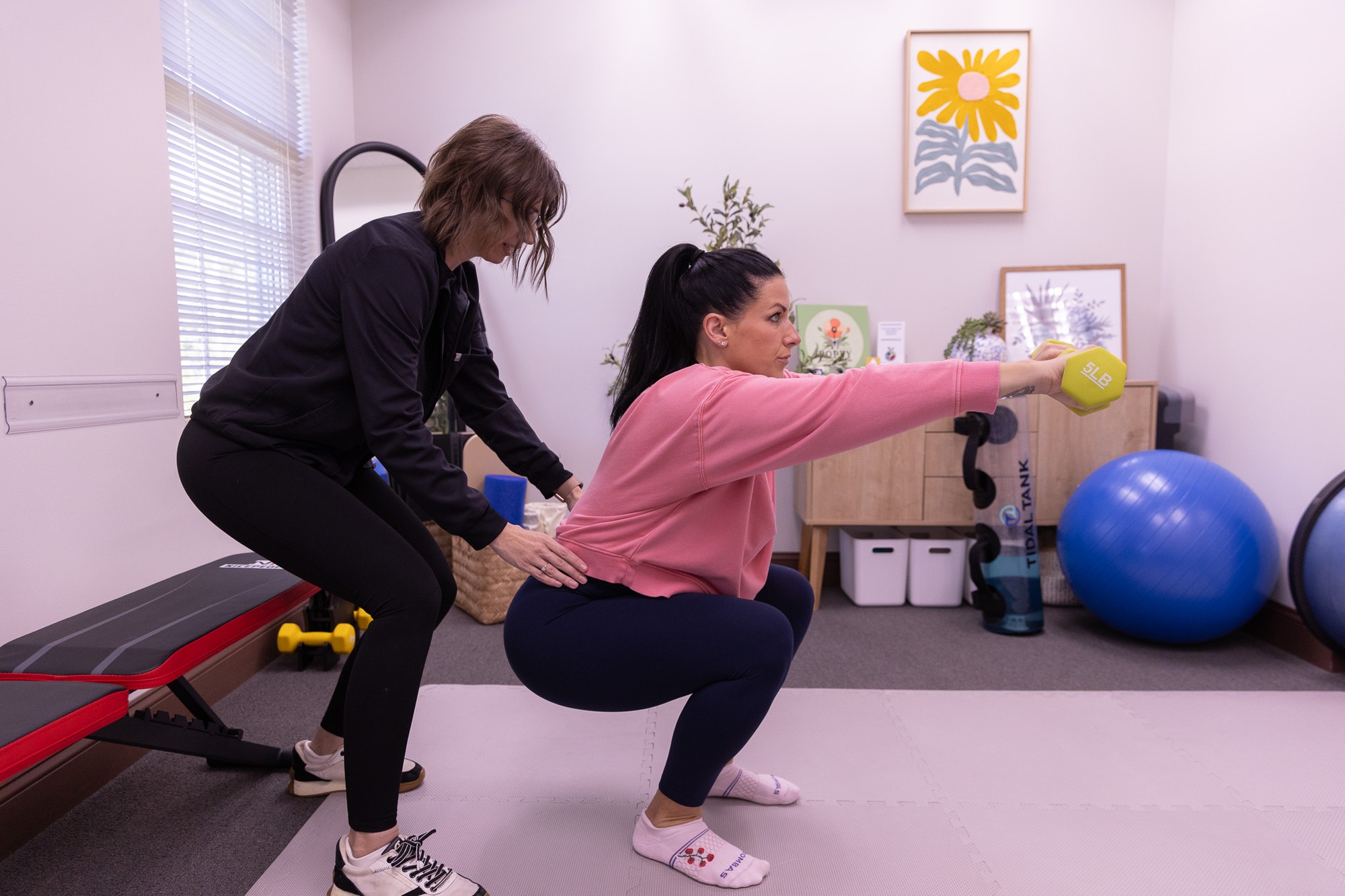 Emily Dumont guiding a patient through hip mobility work