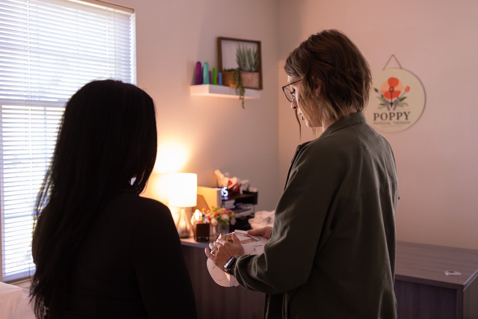 Emily Dumont discussing pelvic health with a patient
