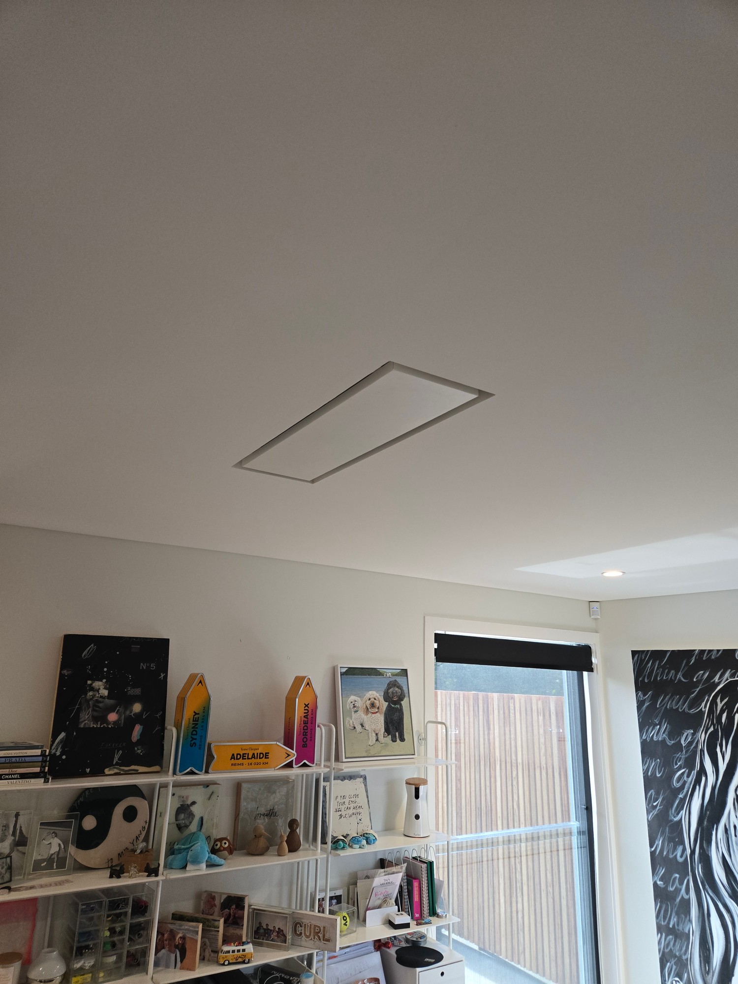 Flush rectangular return air grille set into white plaster ceiling