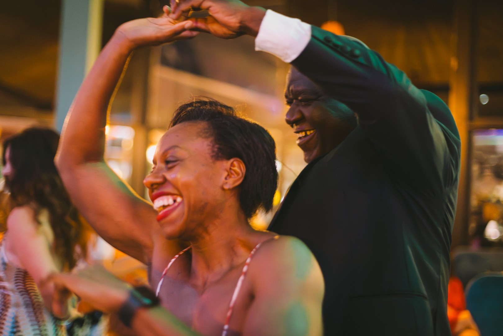 Couple laughing mid-turn on the social night dance floor