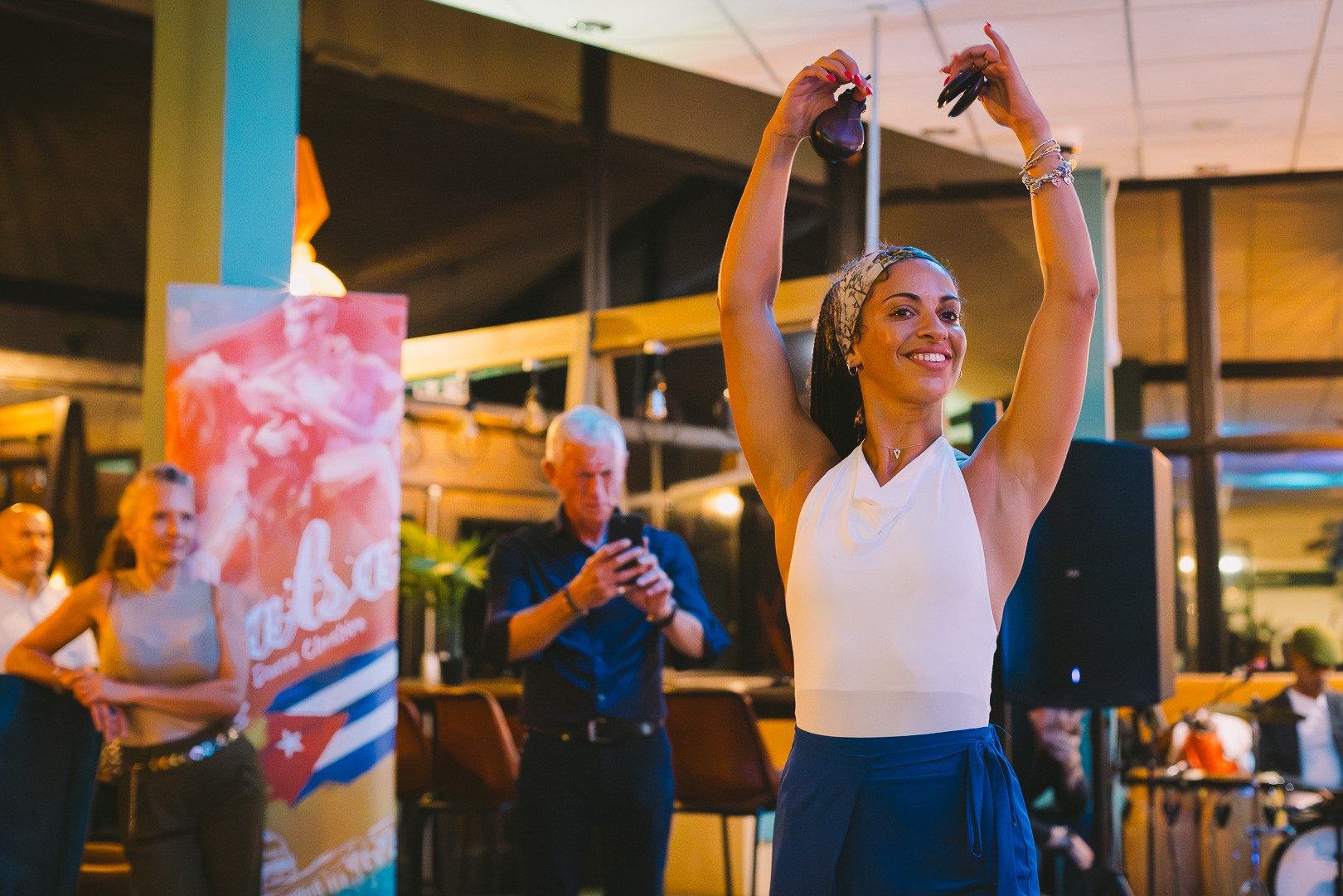 Four friends posing arm in arm at a salsa social night