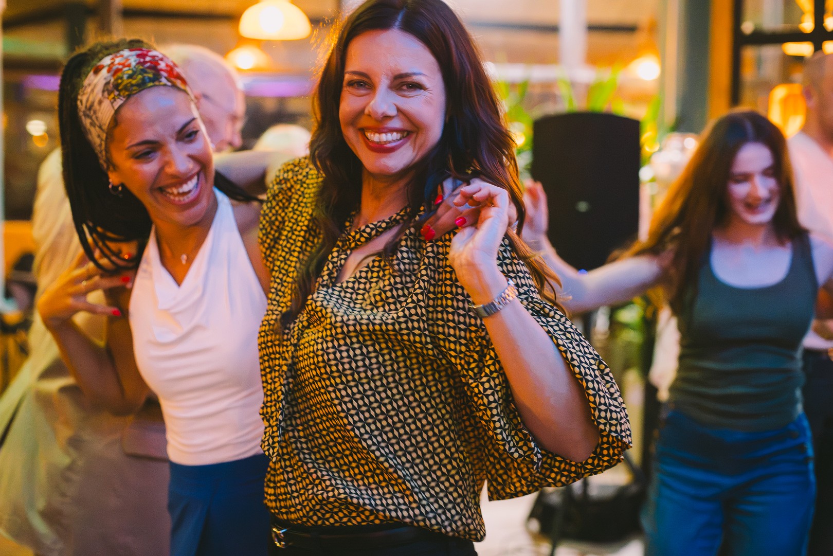 Friends laughing and dancing together at the salsa social