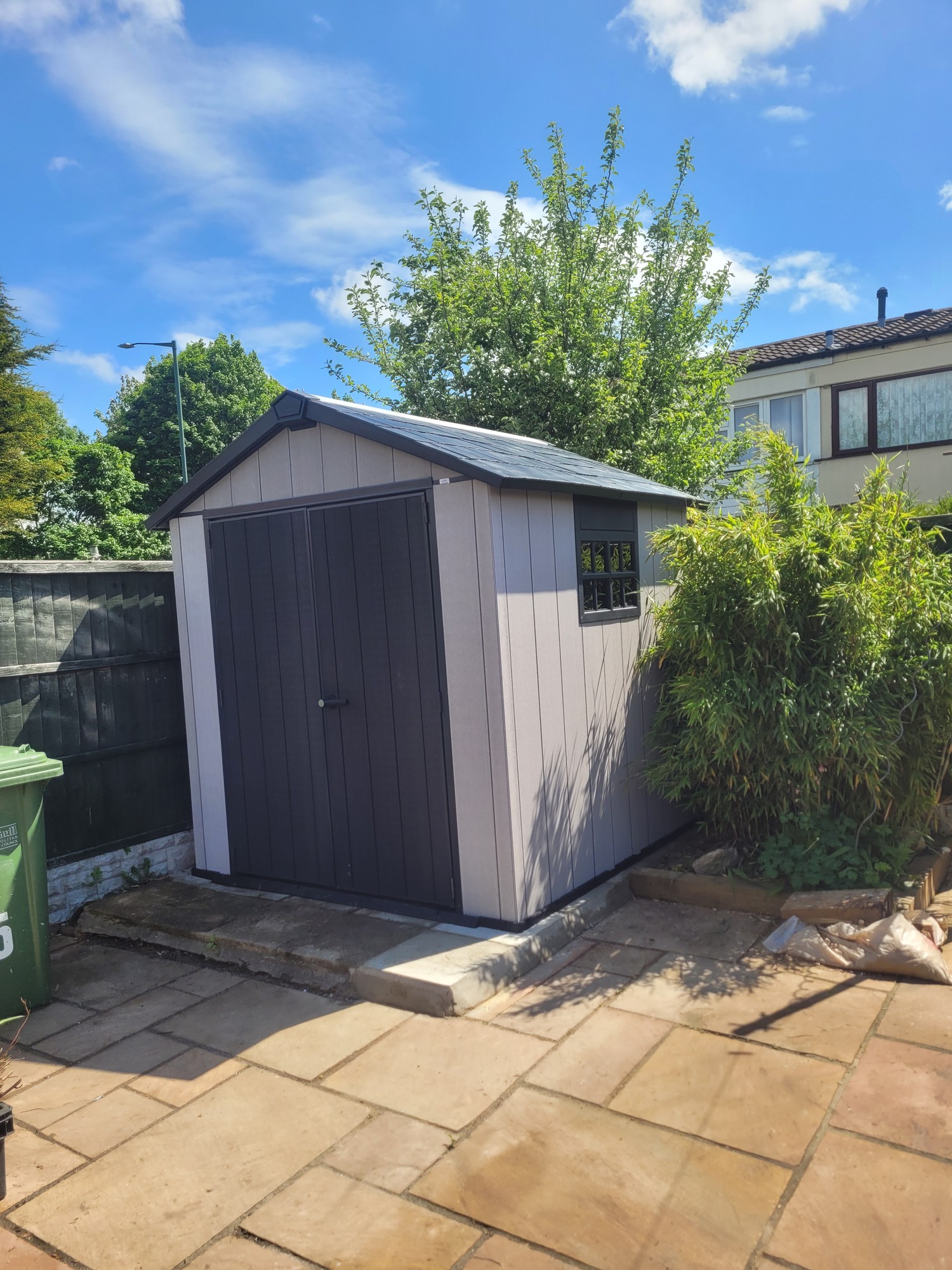 Plastic shed assembled on a paved base