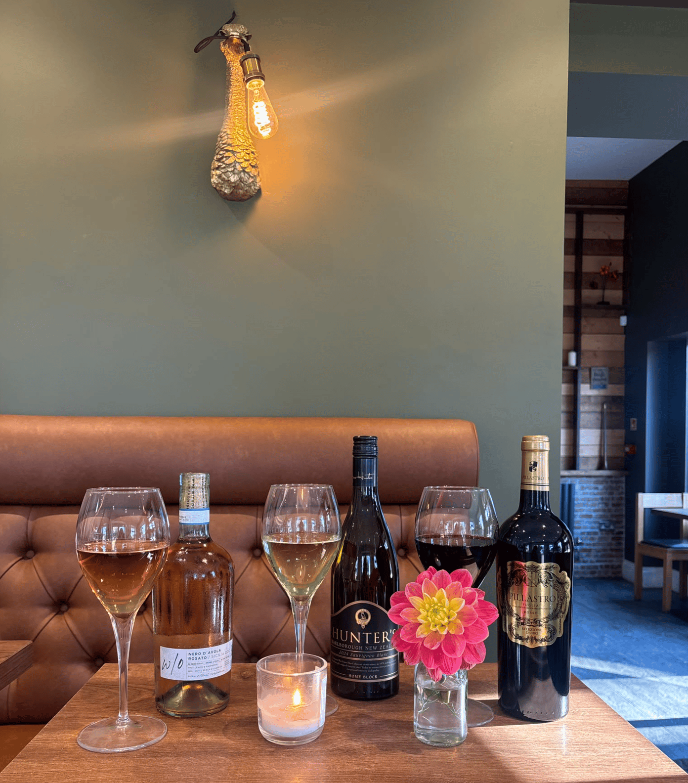 Wine bottles and glasses set for a tasting at The Dovecote Barn