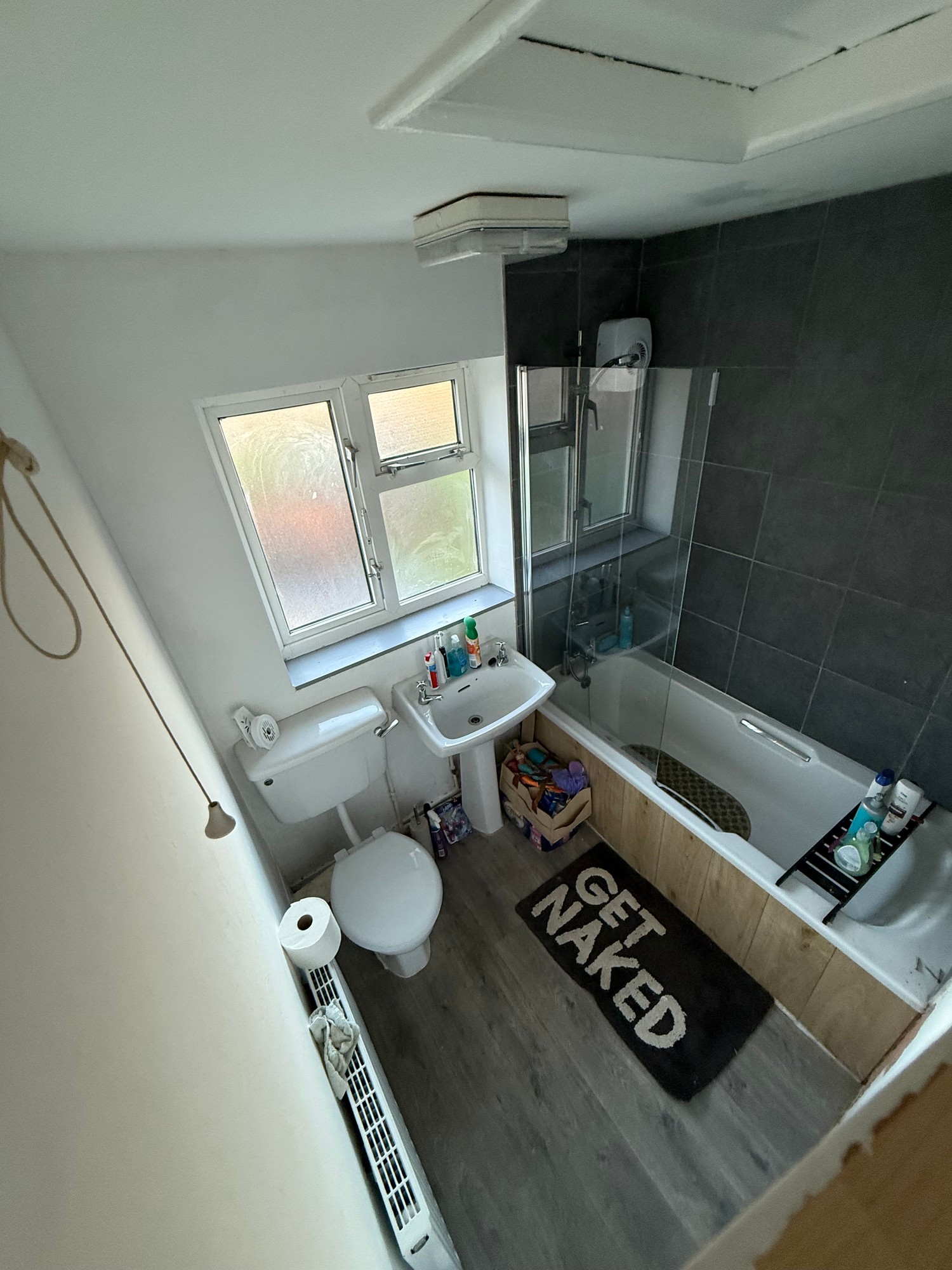 Renovated bathroom with tiled walls and a finished shower area