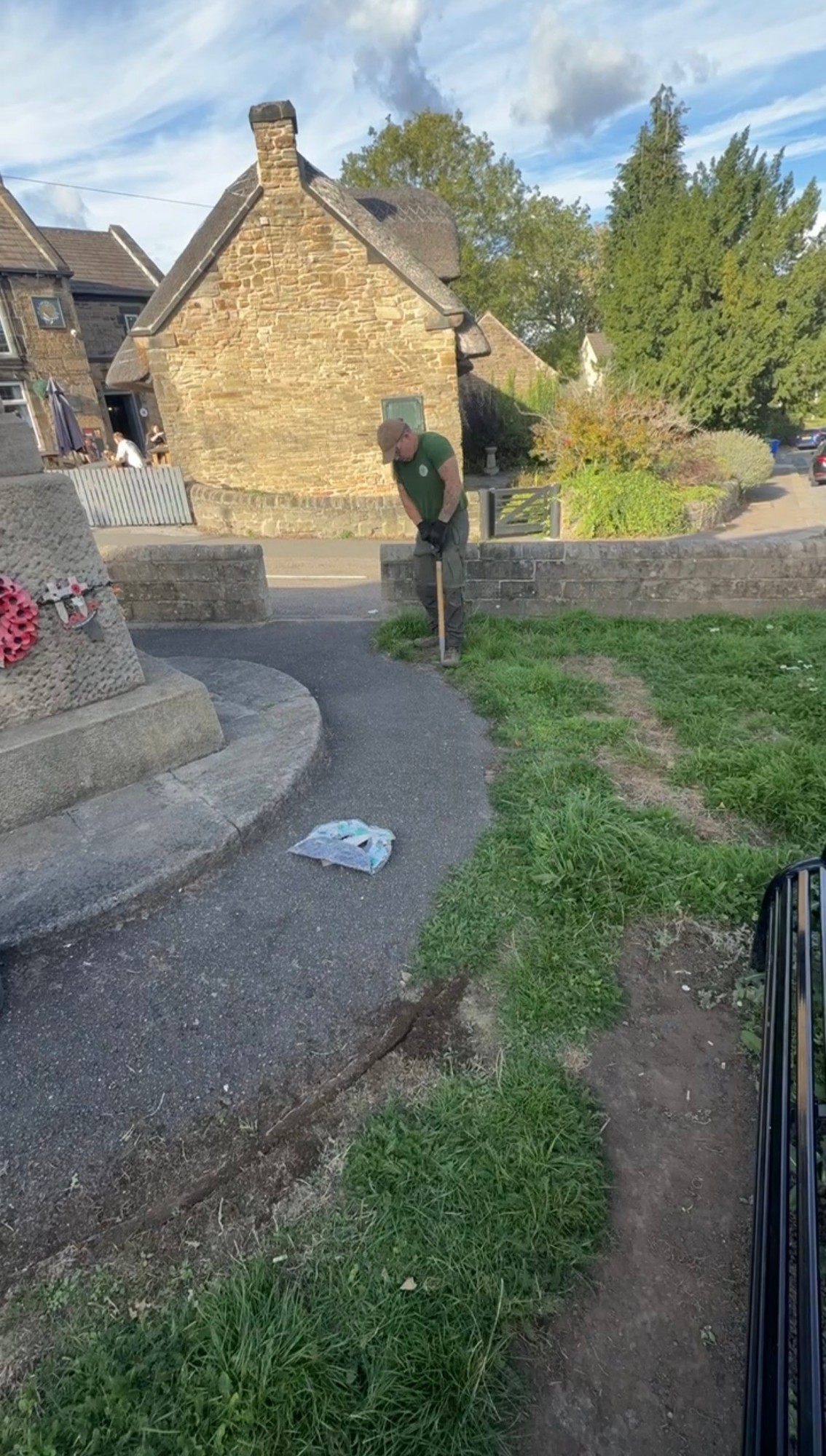 Volunteer clearing the overgrown path leading to the memorial