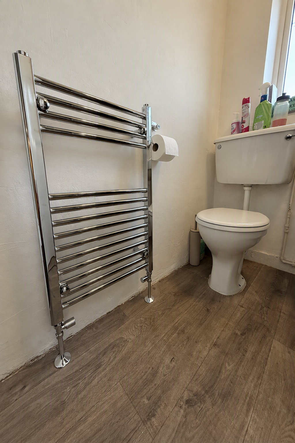 New chrome heated towel rail correctly installed after plumbing work