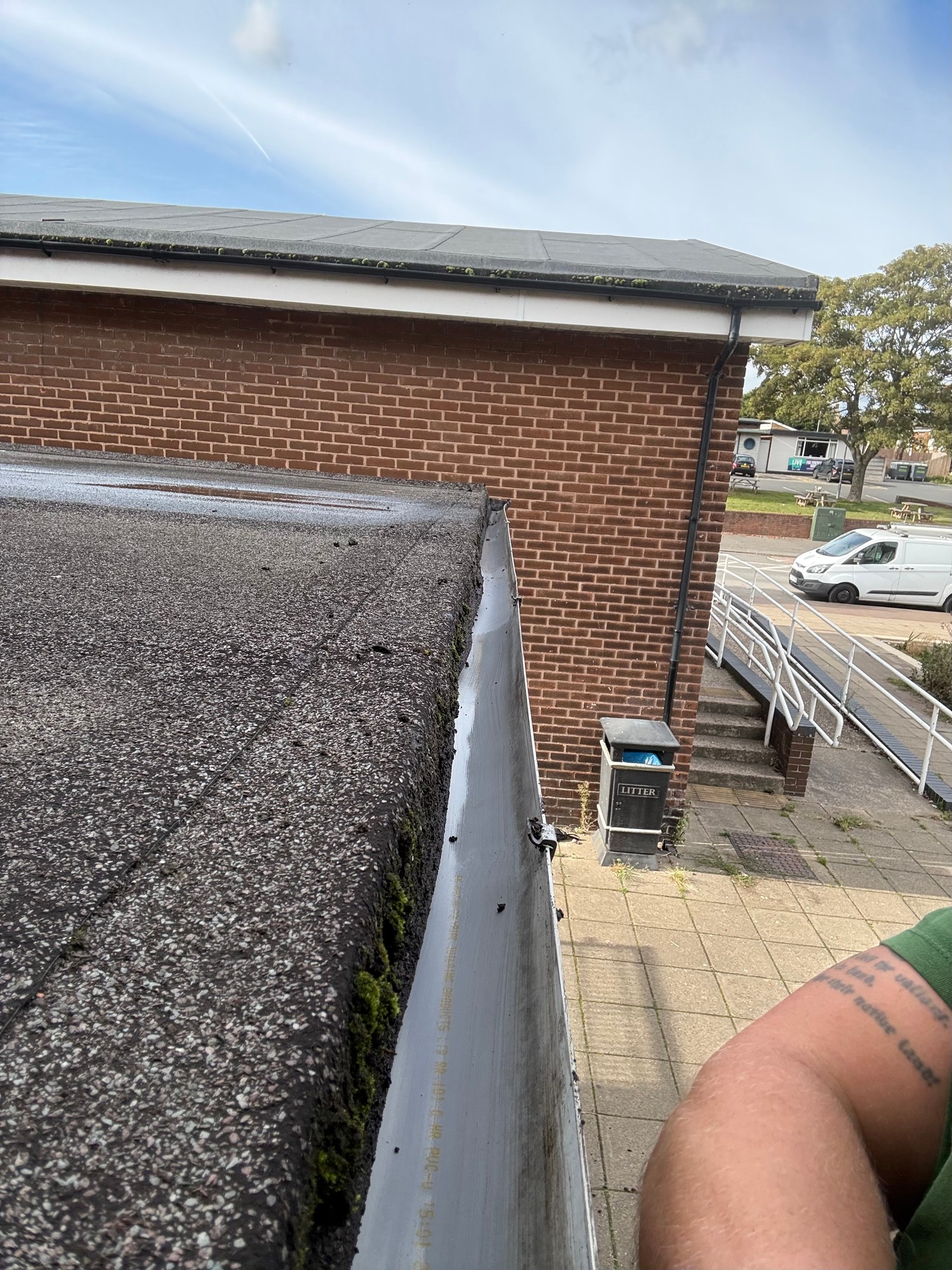 Same gutter cleared of moss and debris after cleaning