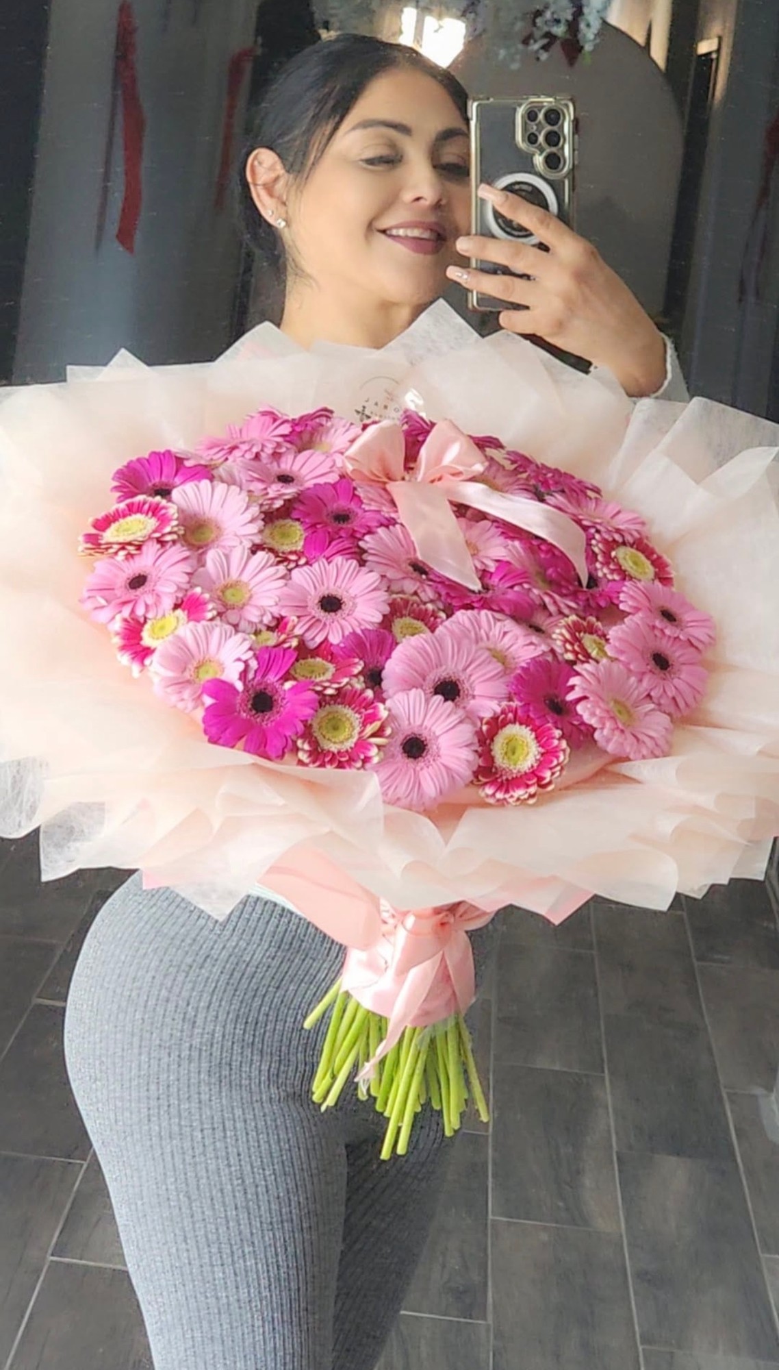 Woman holding beautiful pink gerbera daisy bouquet