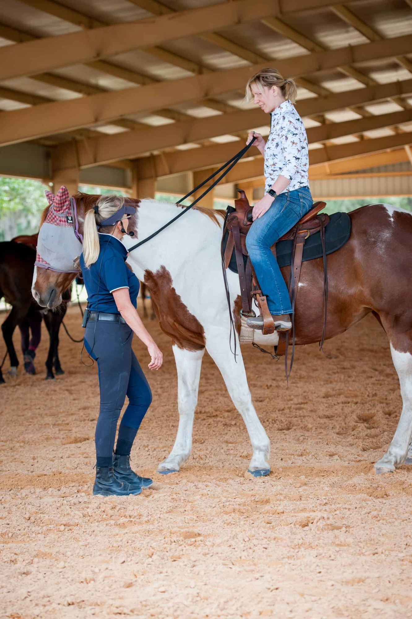 Linda Parelli coaching a rider on a paint horse