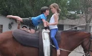 Two kids enjoying time together on horseback