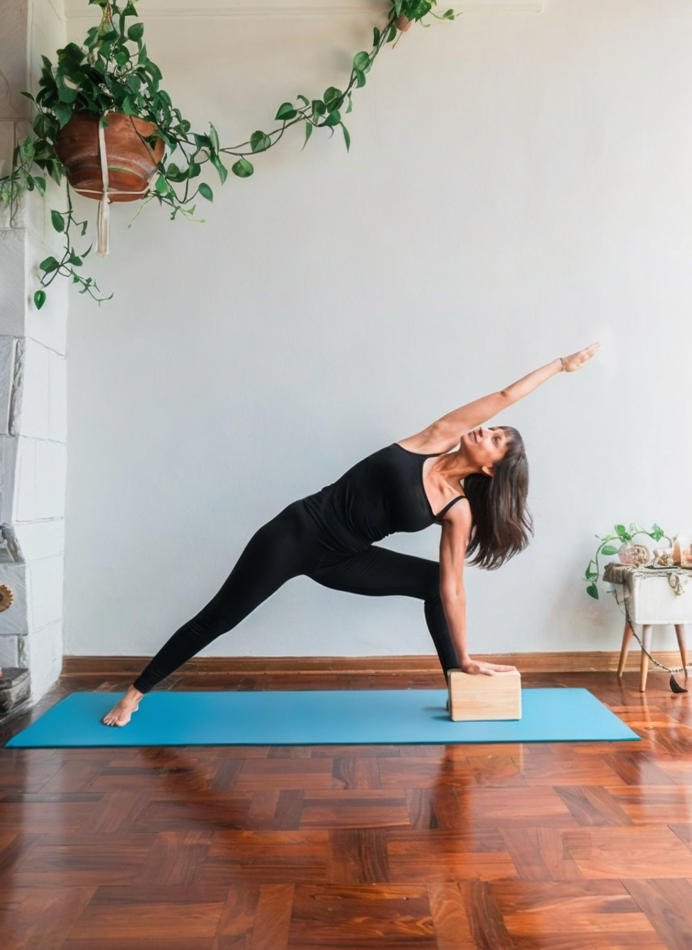 Woman doing yoga pose in home gym setting
