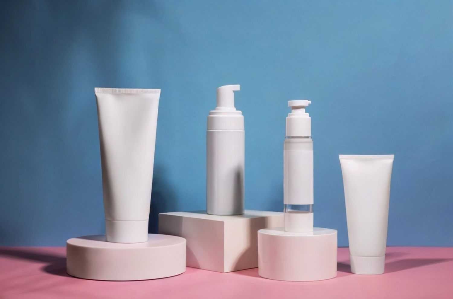 Aesthetic display of skincare bottles on marble backdrop showcasing packaging design