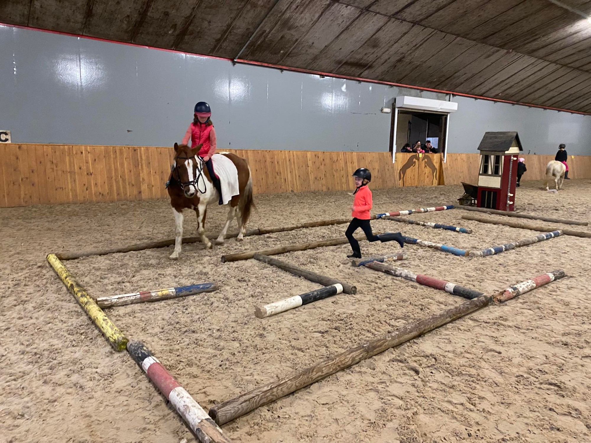 Kind op pony in overdekte rijpiste — les bij Royal Horse Stables