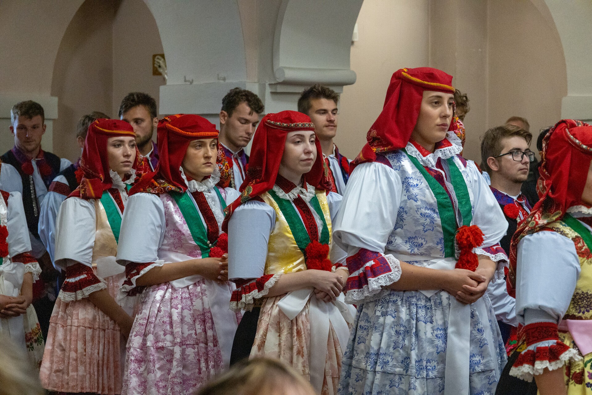 Členové hodové chasy v krojích během mše svaté