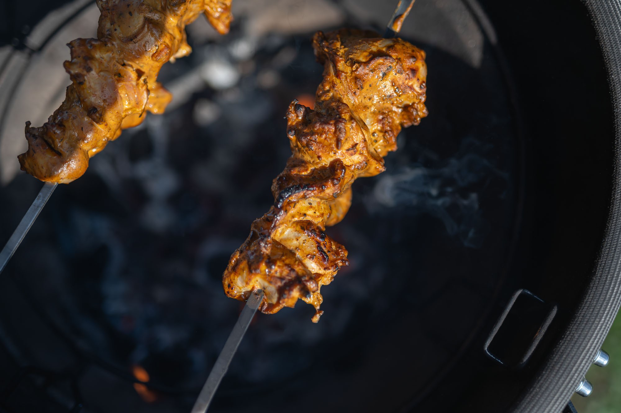 Tandoori kura na ražni nad uhlíkmi
