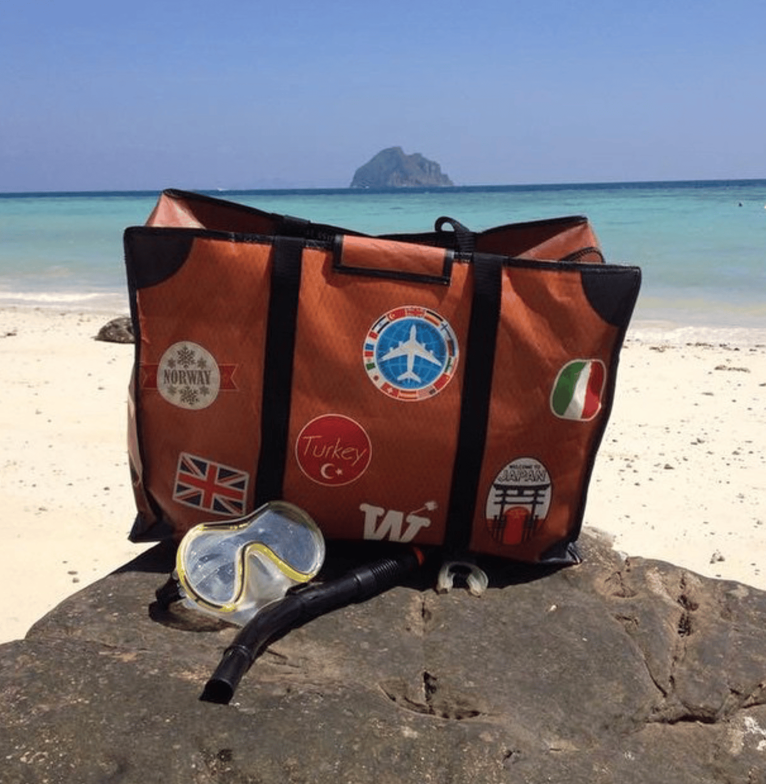 WISSHH Travel Bag in the vintage orange travel-stickers edition, on the road