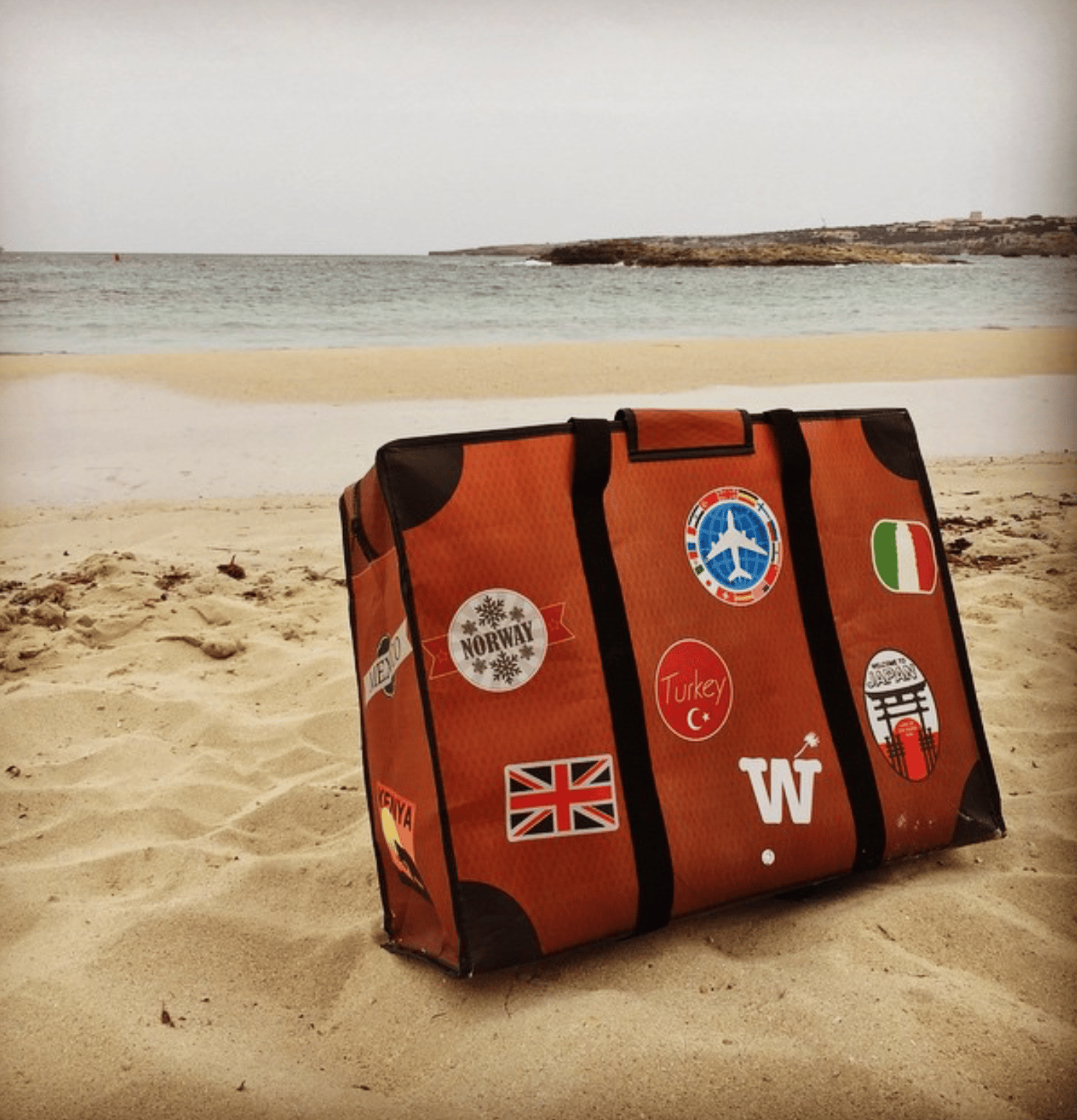 WISSHH Travel Bag in the vintage orange travel-stickers edition, on the road