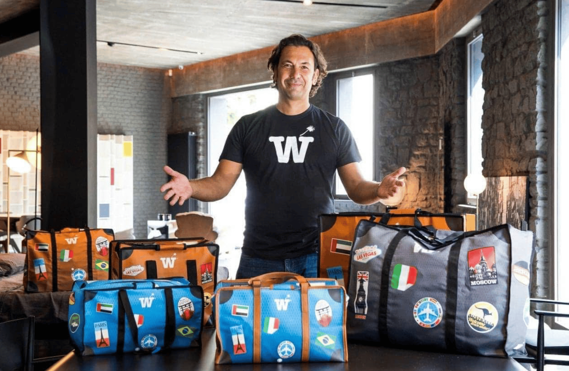 The three WISSHH bags in sky blue, jet black and vintage brown on an airport trolley