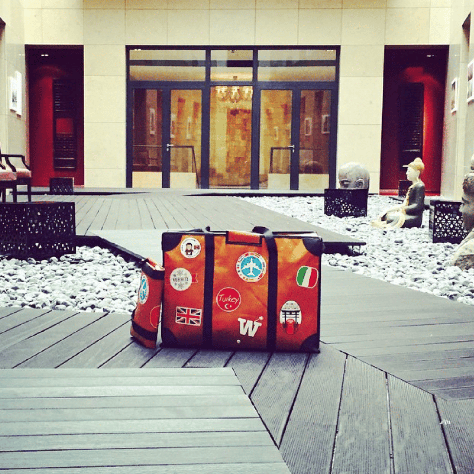 WISSHH Travel Bag in the vintage orange travel-stickers edition, on the road