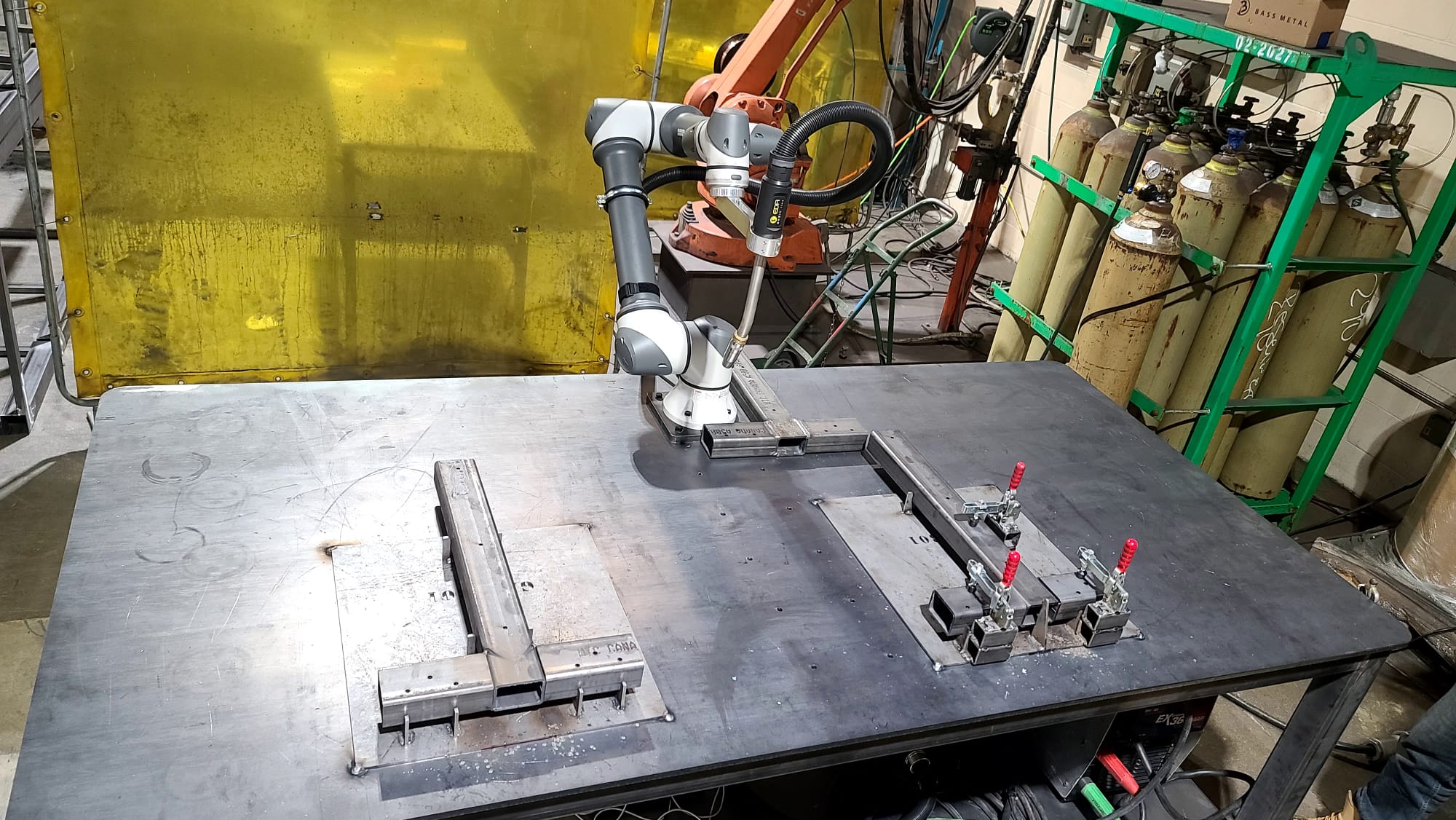 Cobot welding with yellow safety curtain