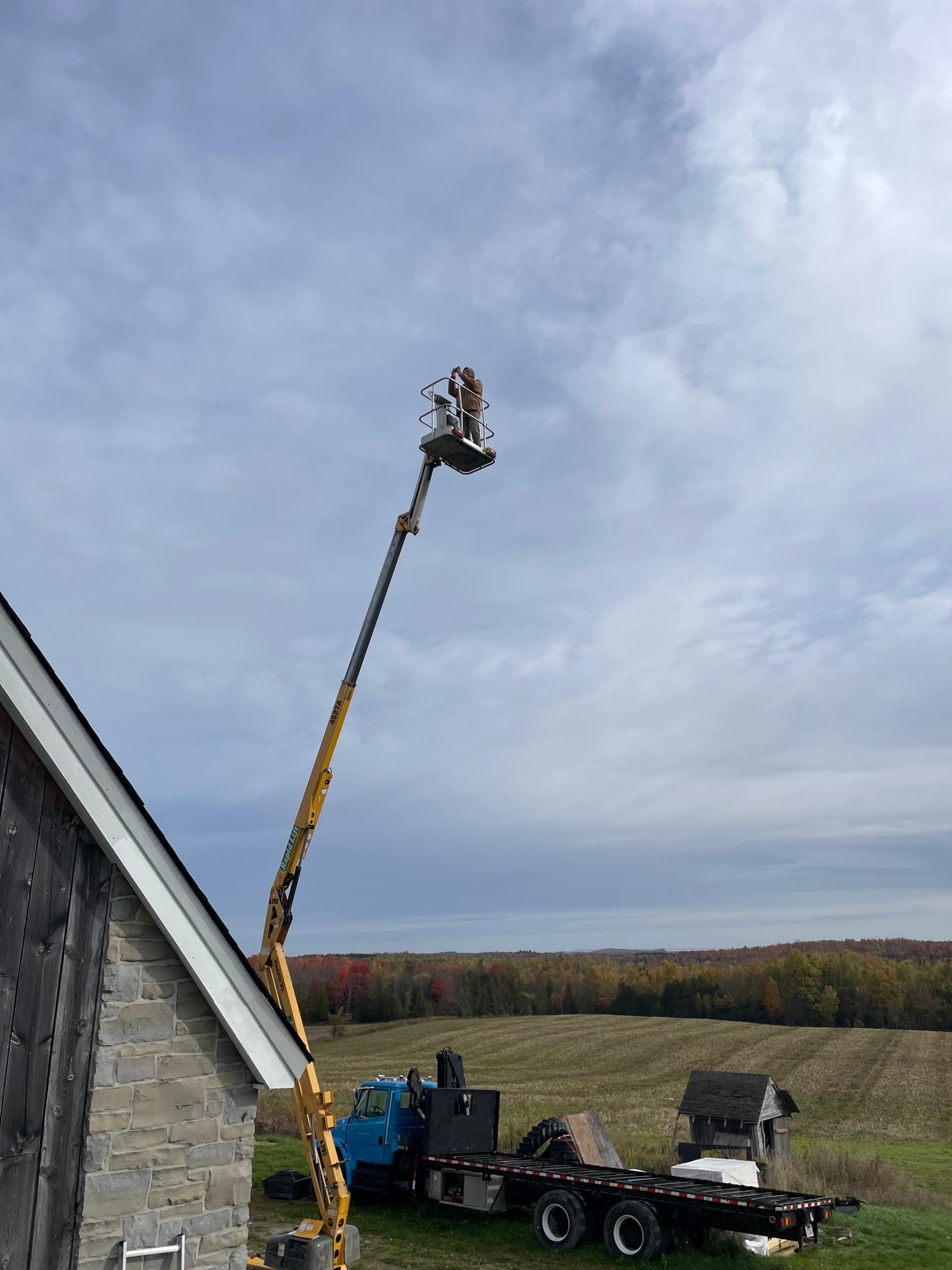 Painter on ladder painting house exterior