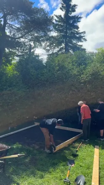 Crew building wooden forms for a concrete slab