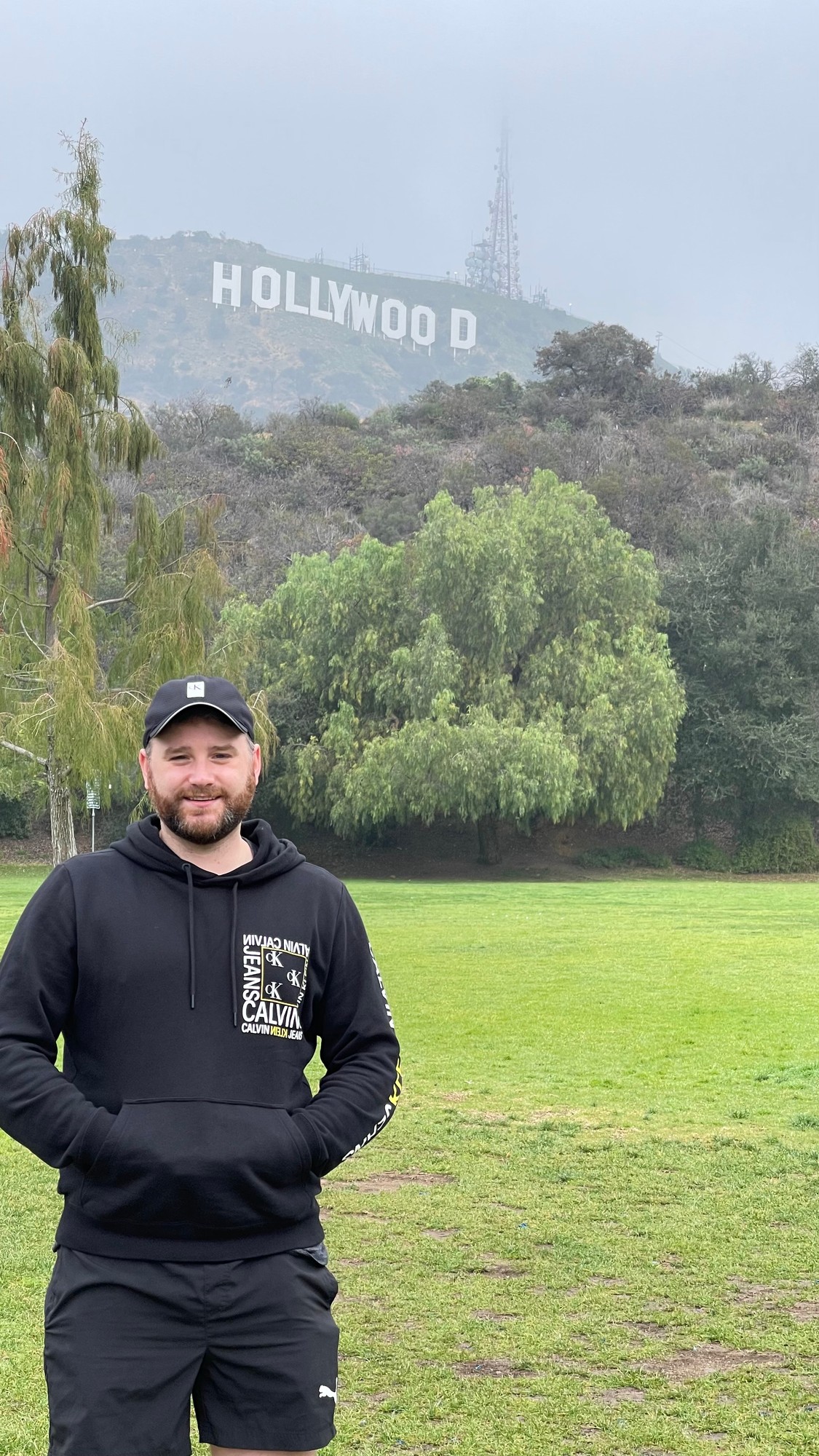 Close-up with the Hollywood Sign clearly visible behind the trees