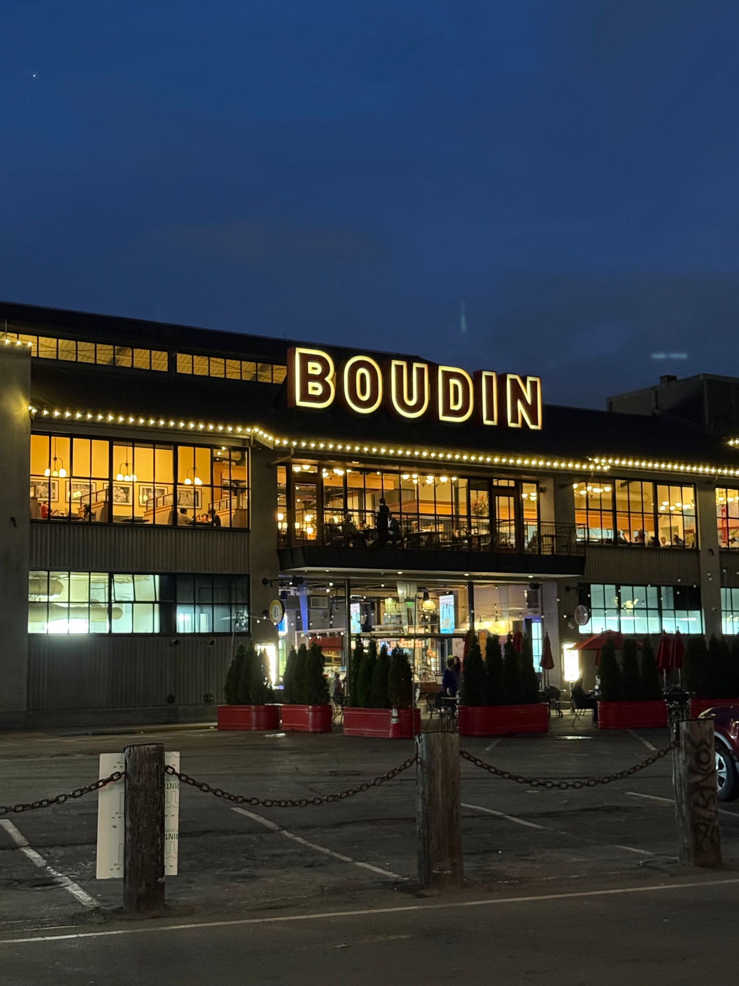 The Boudin bakery building lit up at night at Fisherman's Wharf in San Francisco