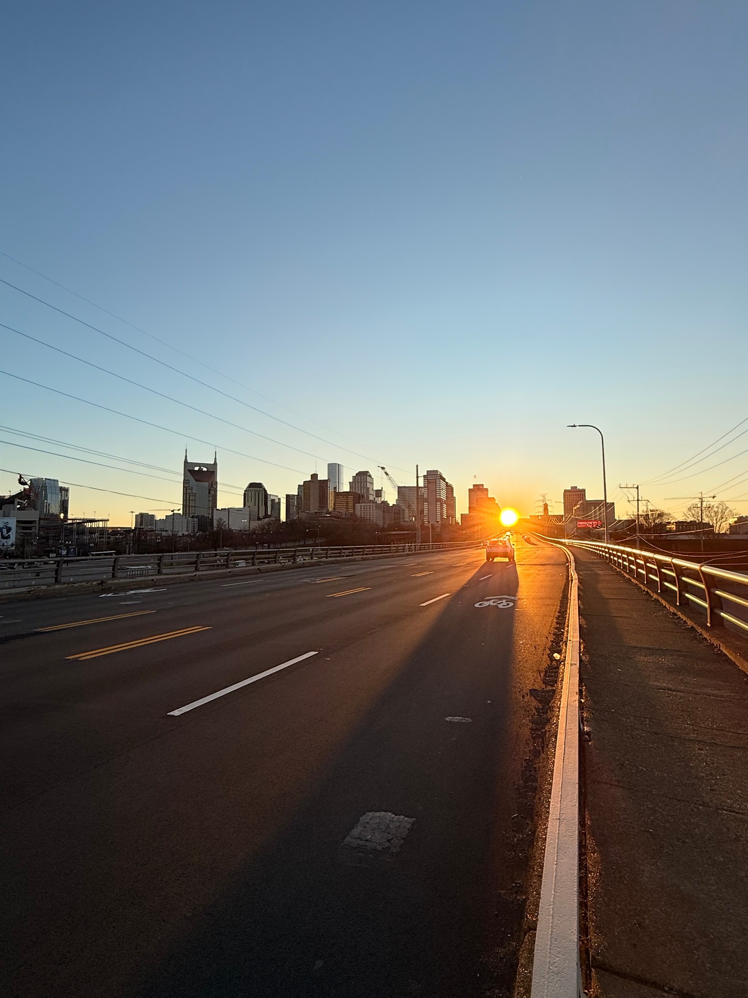 The Nashville skyline at sunset, seen from the bridge heading into downtown