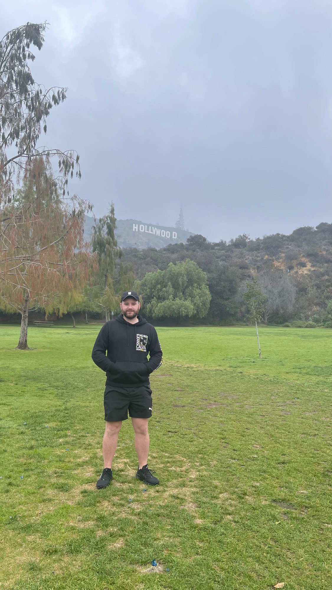 Me at Lake Hollywood Park with the Hollywood Sign on the hillside behind