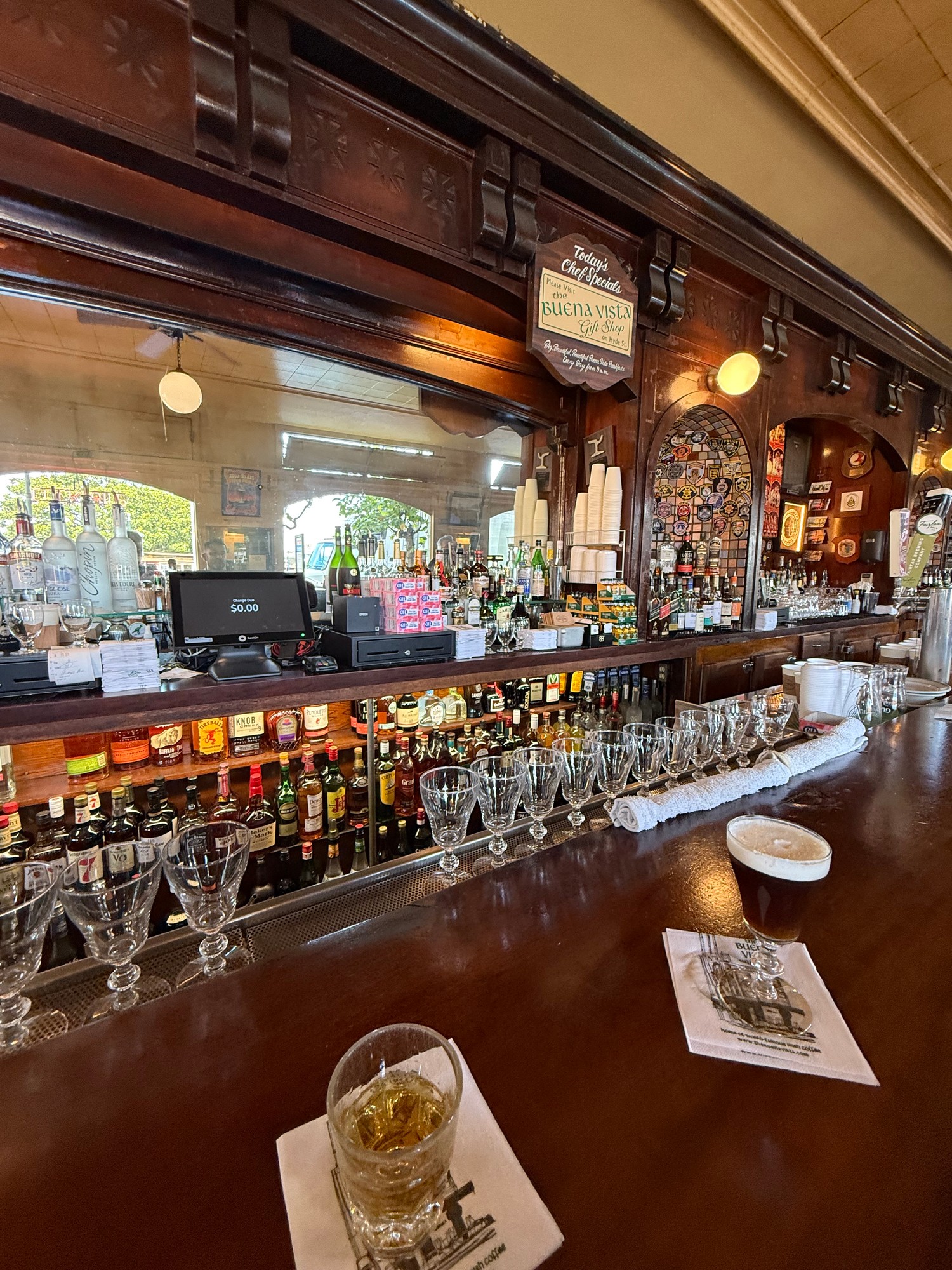 The Buena Vista Cafe bar in San Francisco with an Irish coffee and rows of empty serve glasses