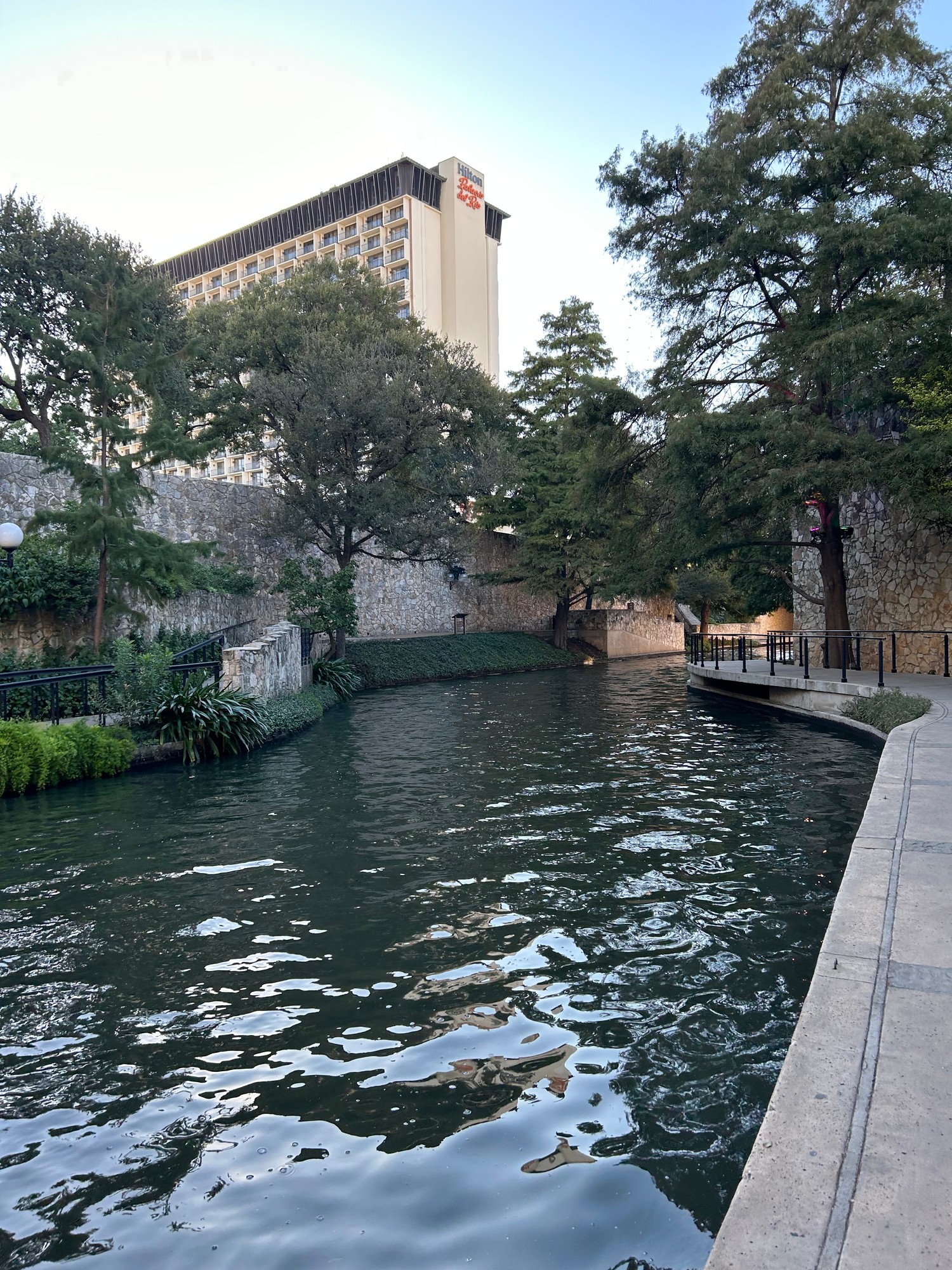 The Hilton Palacio del Rio rising above the San Antonio River Walk at dusk